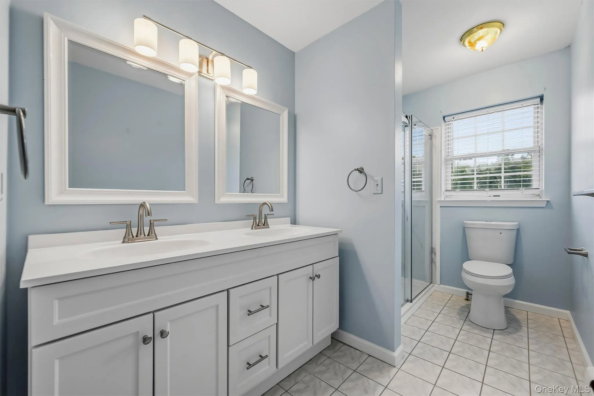 The private en suite features a double vanity and a crisp, updated look. The private en suite features a double vanity and a crisp, updated look.