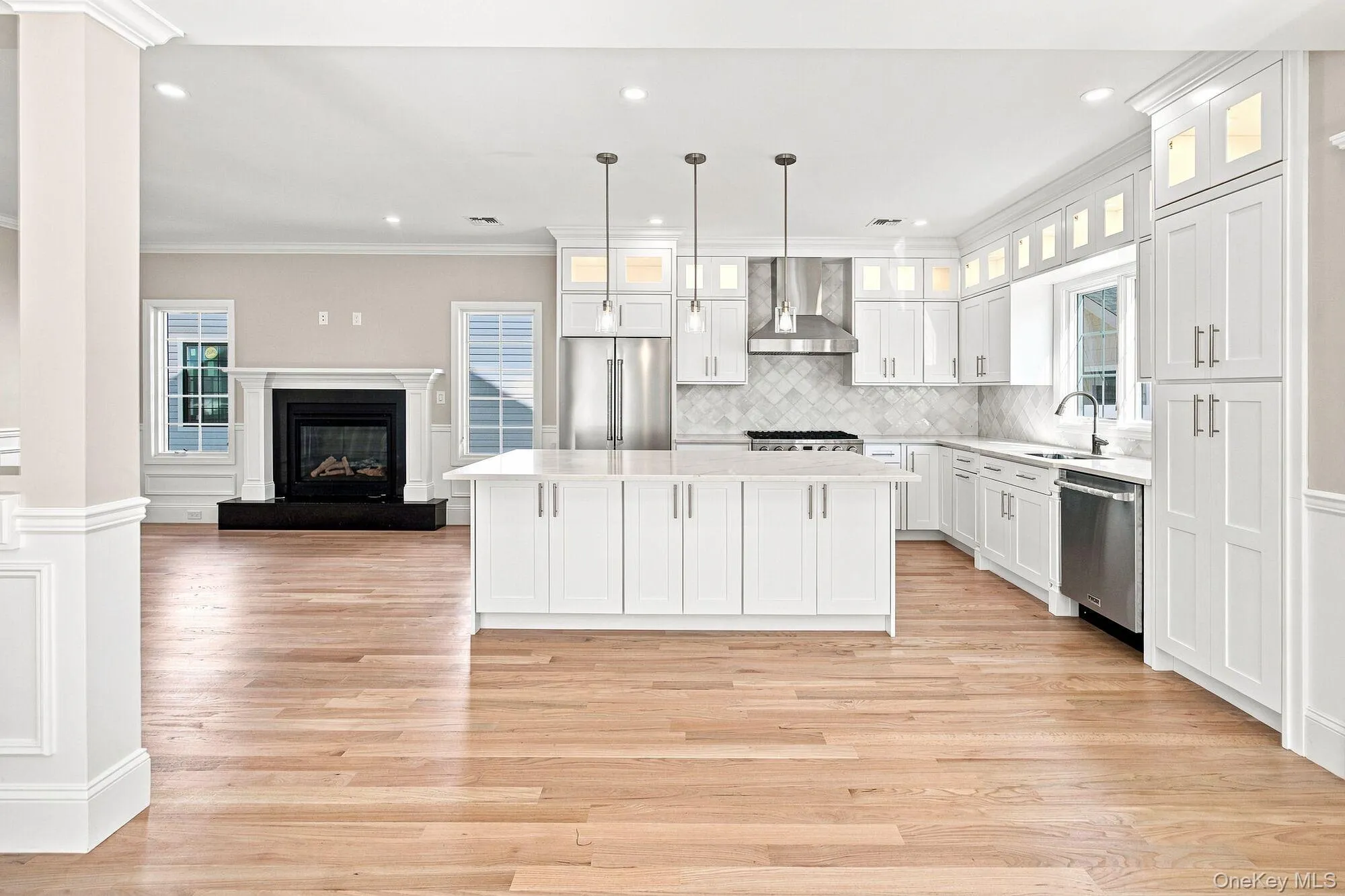 Spacious Kitchen with white shaker cabinetry, stainless steel appliances, and a central island with pendant lighting. Spacious Kitchen with white shaker cabinetry, stainless steel appliances, and a central island with pendant lighting.