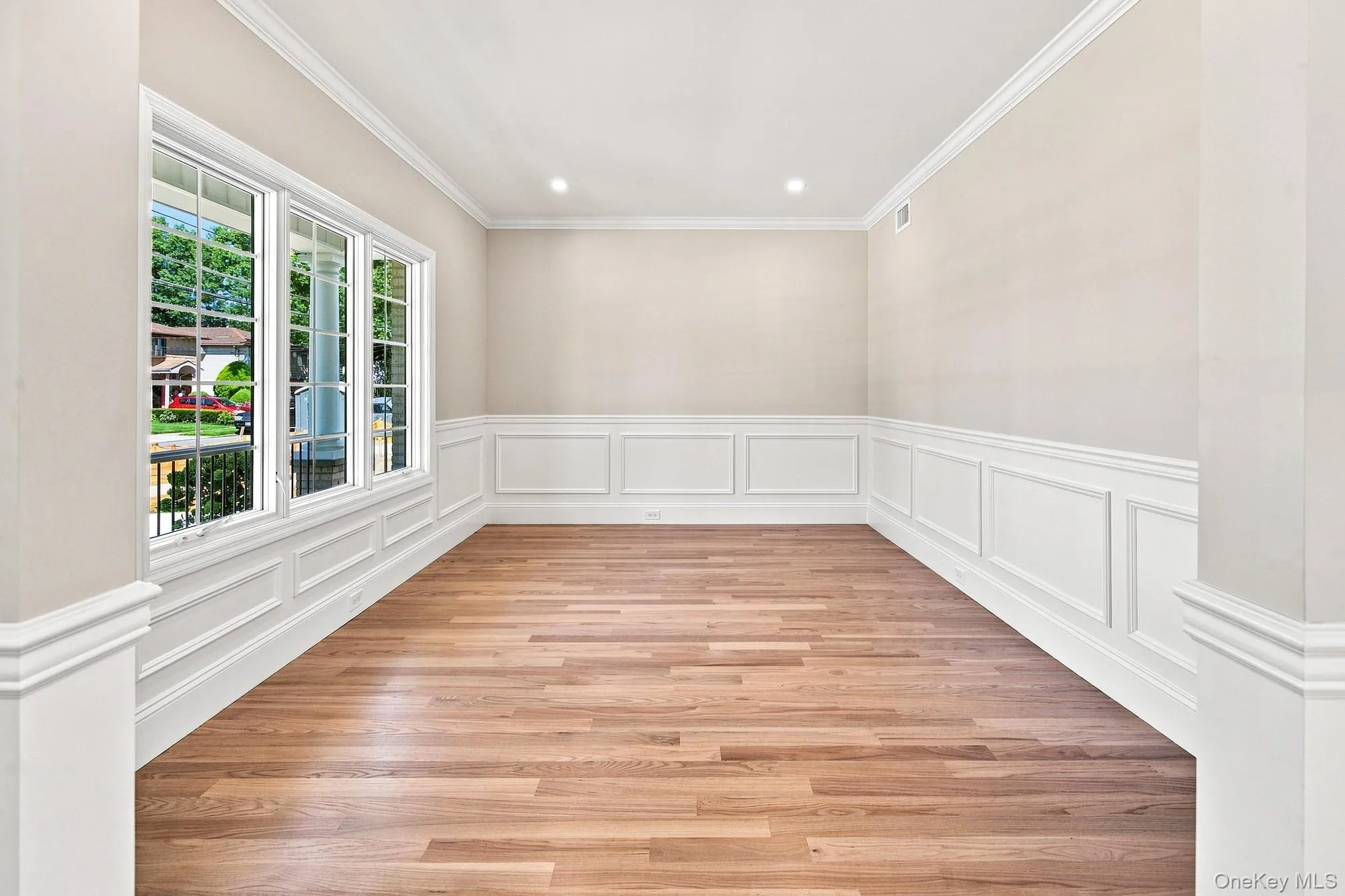 Flexible space: office, study, den, playroom. Wood-finish flooring, white paneled wainscoting, crown molding, recessed lighting, and multiple windows bringing wonderful natural lighting. Flexible space: office, study, den, playroom. Wood-finish flooring, white paneled wainscoting, crown molding, recessed lighting, and multiple windows bringing wonderful natural lighting.