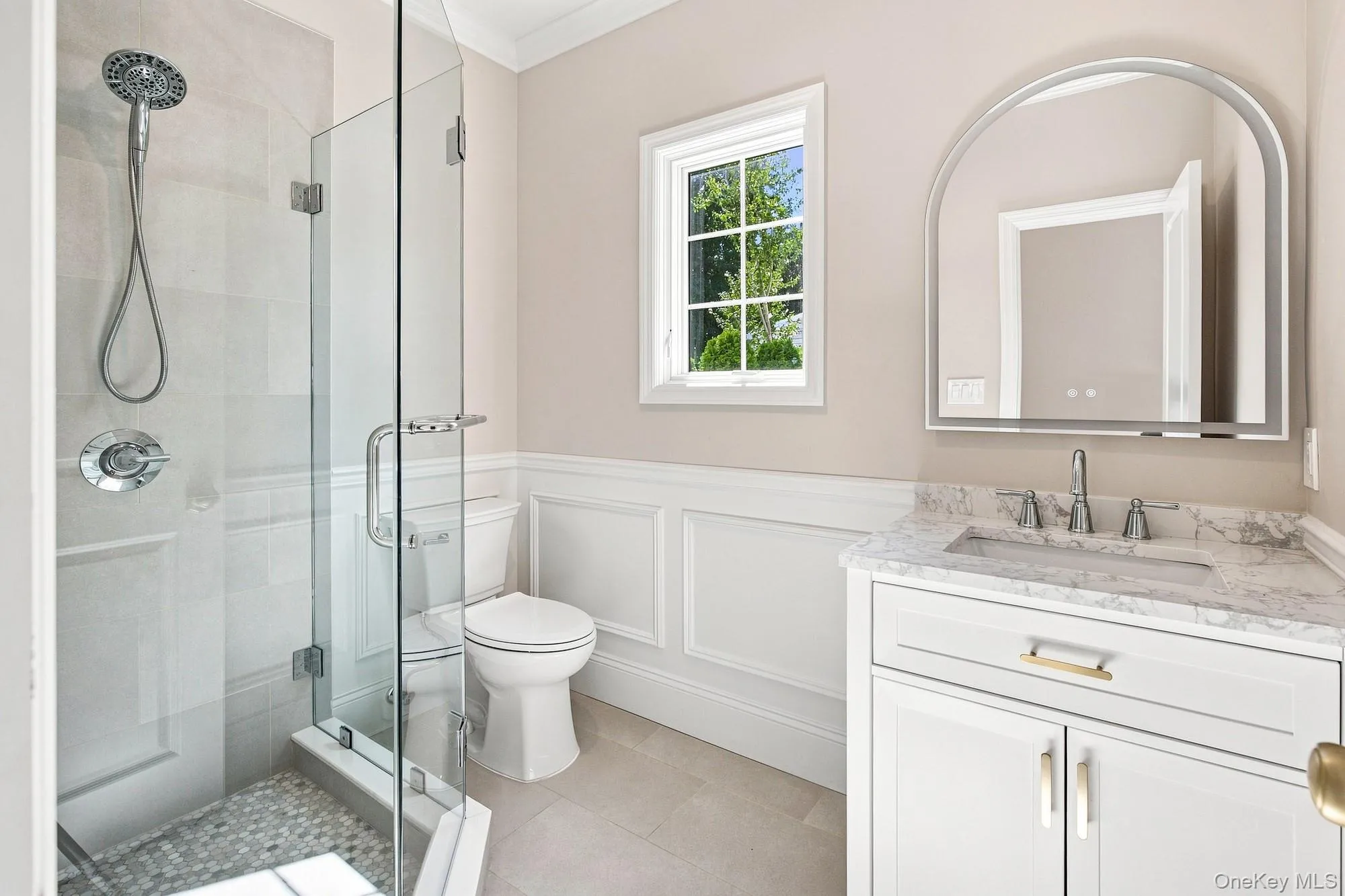 First Floor full bath - glass-enclosed shower with pebble-tile flooring and chrome fixtures First Floor full bath - glass-enclosed shower with pebble-tile flooring and chrome fixtures