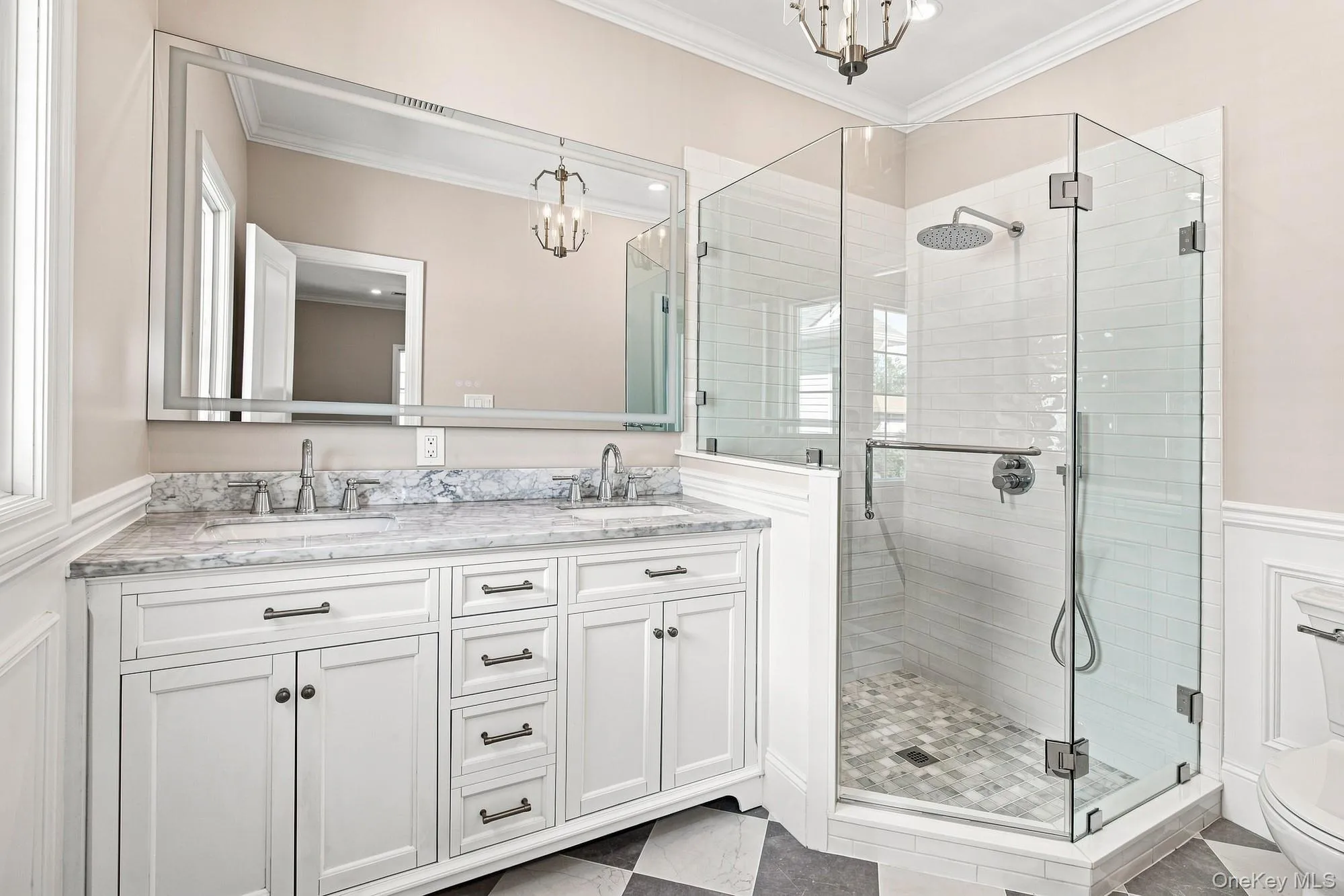 Dual vanity with under mount sinks, stone countertop, and an expansive mirror, large shower. Dual vanity with under mount sinks, stone countertop, and an expansive mirror, large shower.