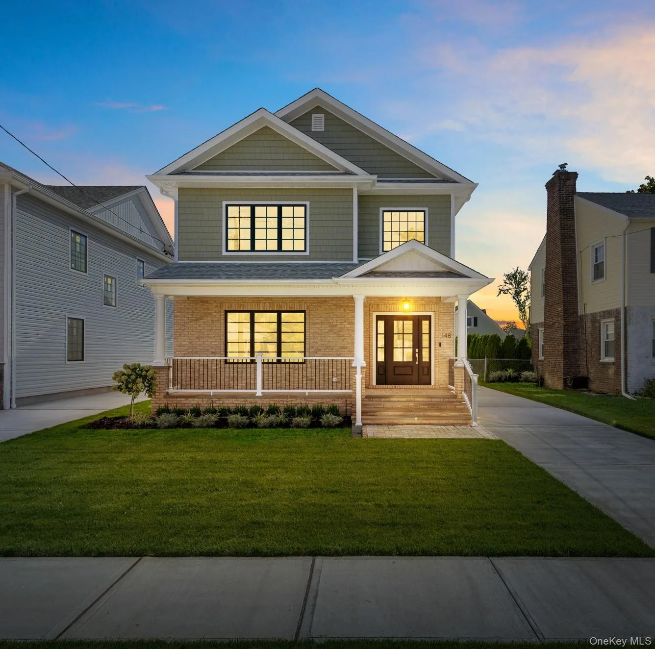 Twilight: Gable roof lines with shake siding, brick facade, covered front porch, double entry doors. Twilight: Gable roof lines with shake siding, brick facade, covered front porch, double entry doors.