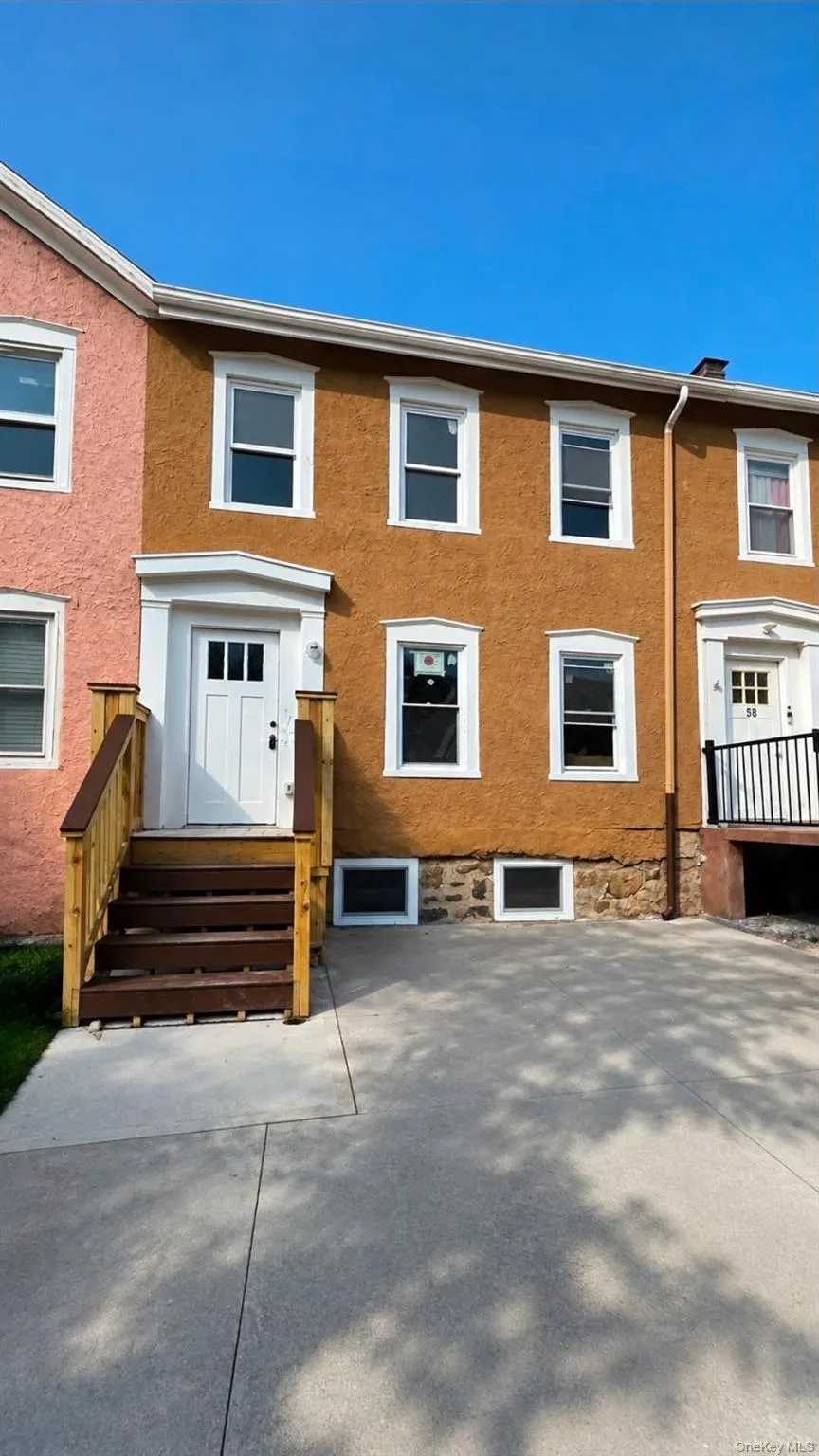 Two-story stucco exterior featuring white-framed windows Two-story stucco exterior featuring white-framed windows