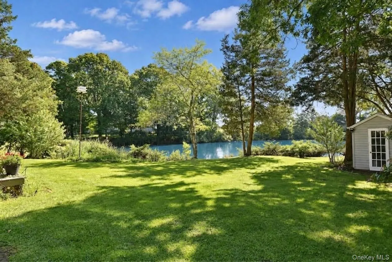 Large yard with gardens and a shed Large yard with gardens and a shed