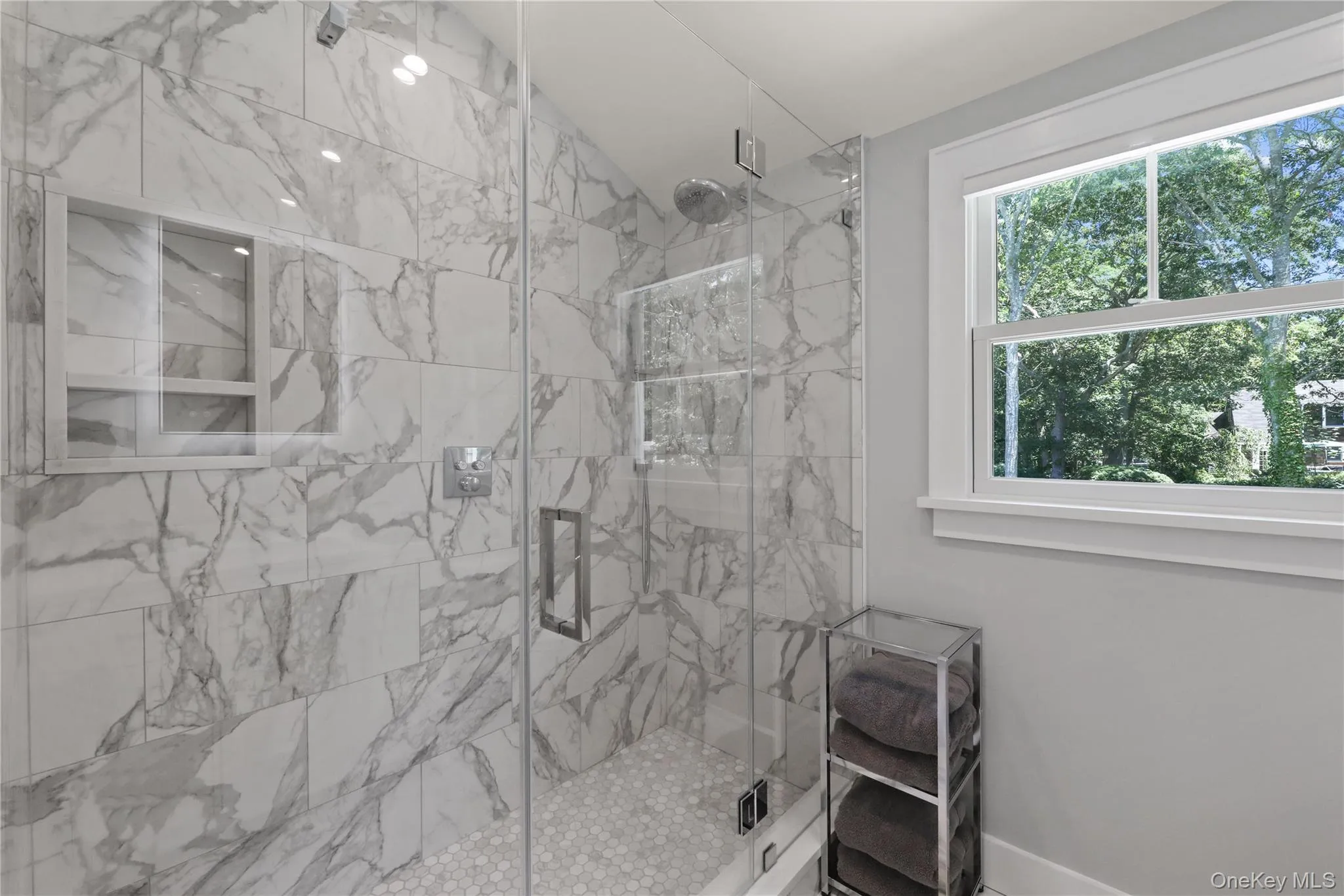 Full bathroom with a marble finish shower Full bathroom with a marble finish shower