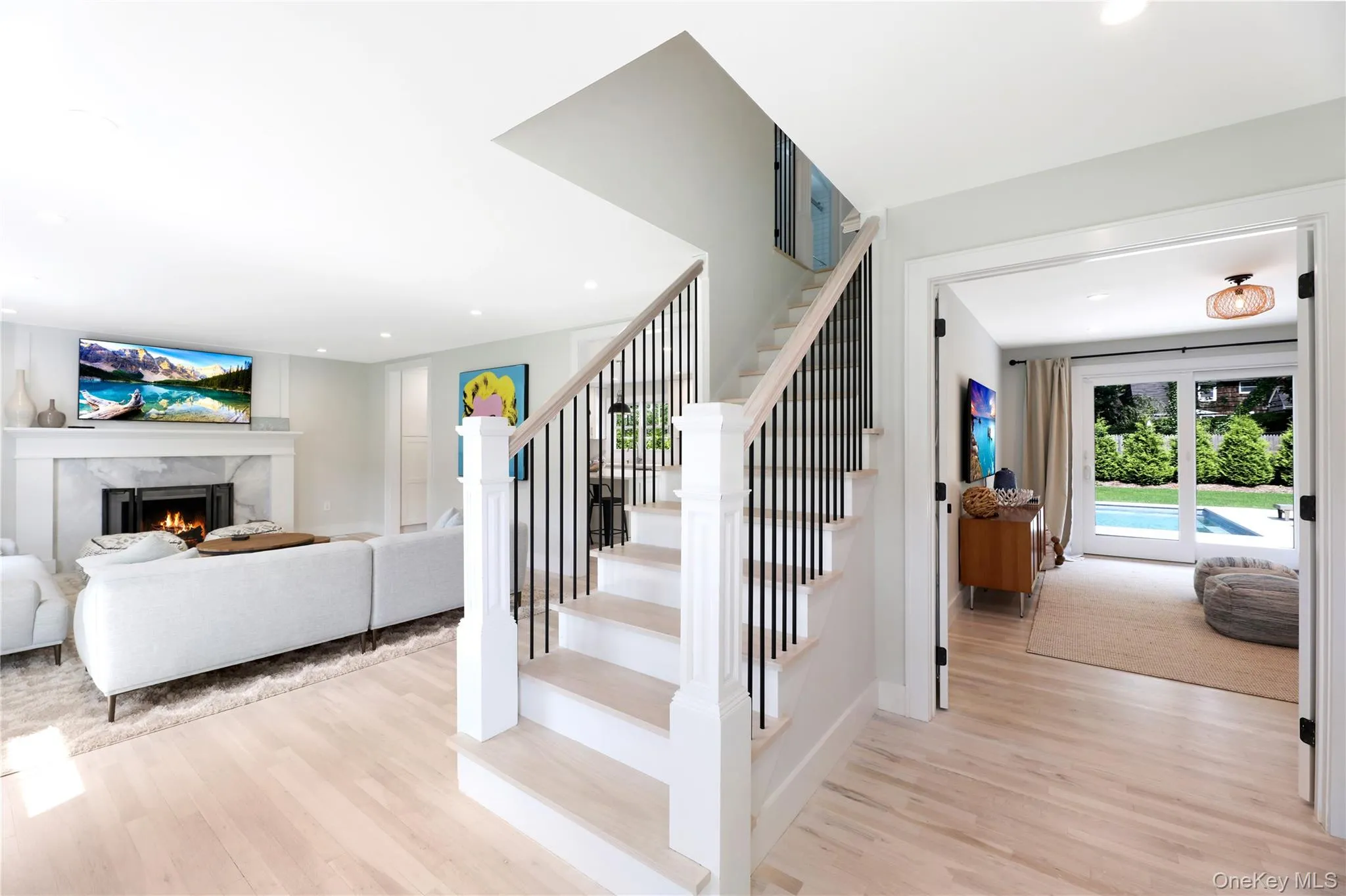 Staircase with wood finished floors, a premium fireplace, and recessed lighting Staircase with wood finished floors, a premium fireplace, and recessed lighting