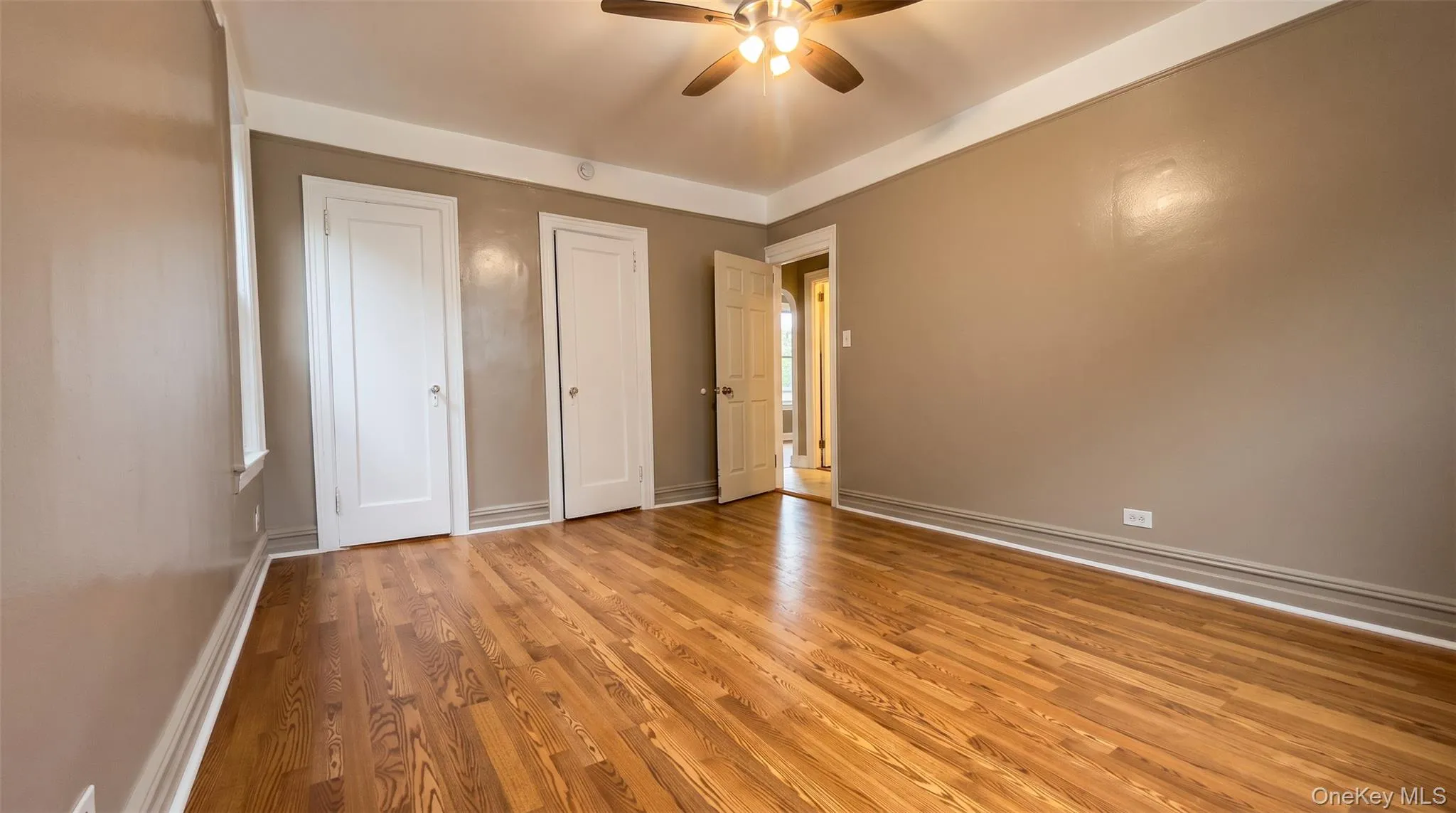 Hardwood flooring throughout, ceiling fan with integrated lighting, white trim, and two panel doors Hardwood flooring throughout, ceiling fan with integrated lighting, white trim, and two panel doors