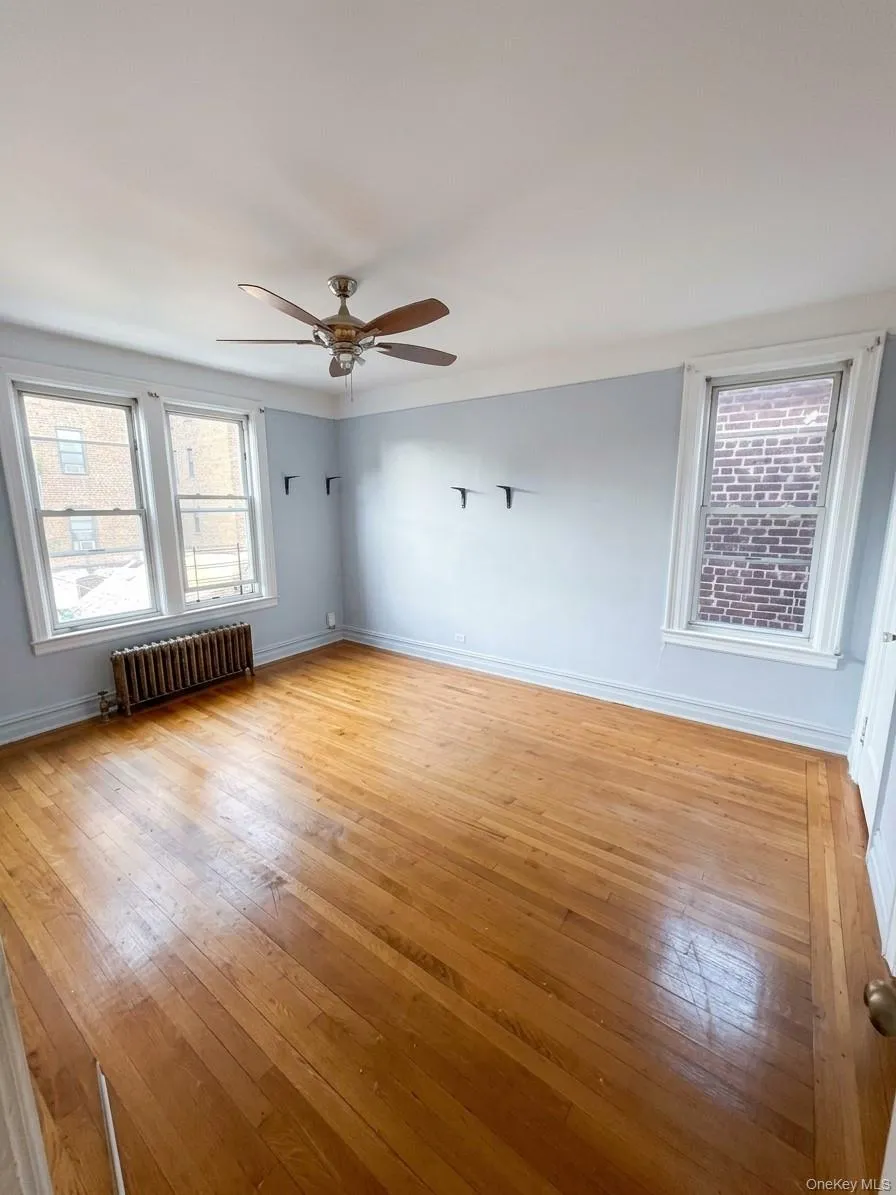 Hardwood flooring throughout, multiple windows, ceiling fan, and painted walls Hardwood flooring throughout, multiple windows, ceiling fan, and painted walls