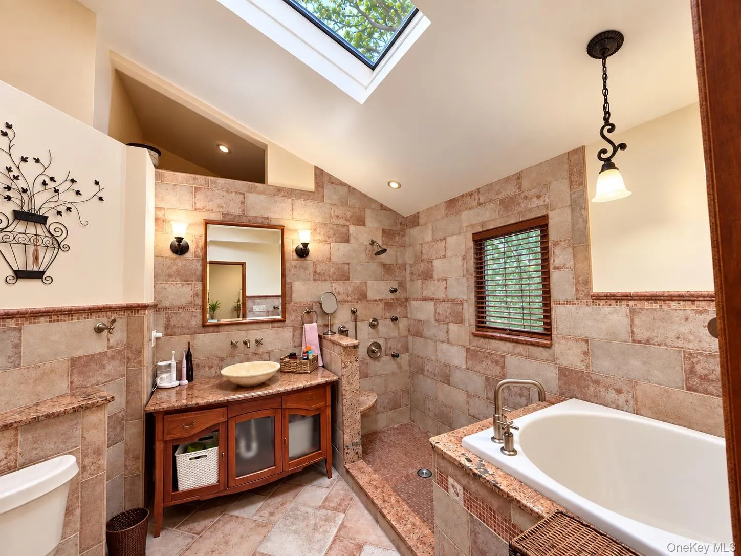 Cathedral ceilings with skylight. Stone shower and deep soaking custom tub Cathedral ceilings with skylight. Stone shower and deep soaking custom tub
