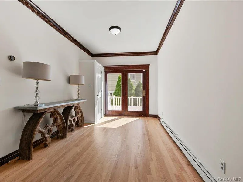 Spacious living room opens to dining room. with glass doors to rear deck Spacious living room opens to dining room. with glass doors to rear deck