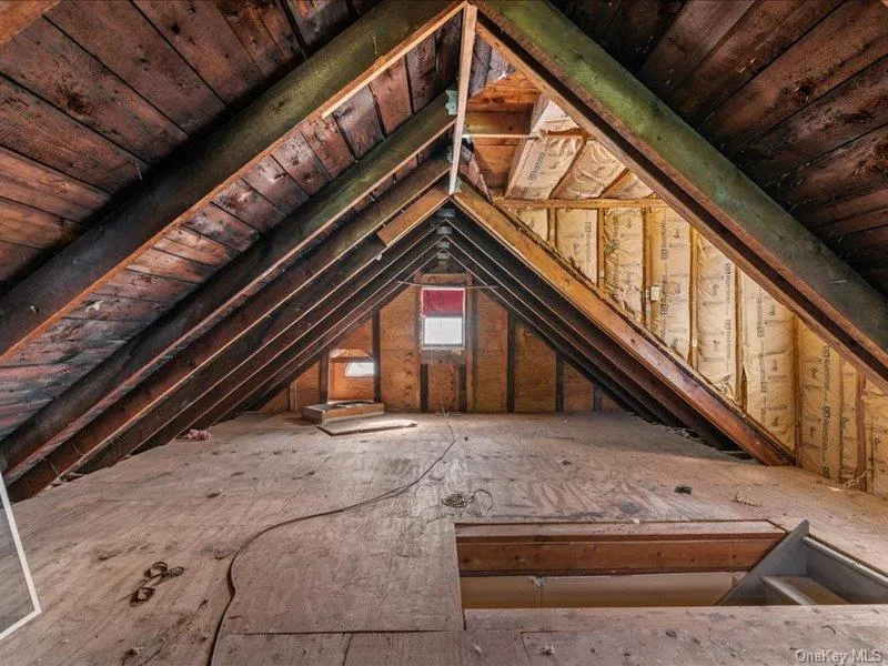 Full walk-up attic with plywood flooring throughout. Full walk-up attic with plywood flooring throughout.