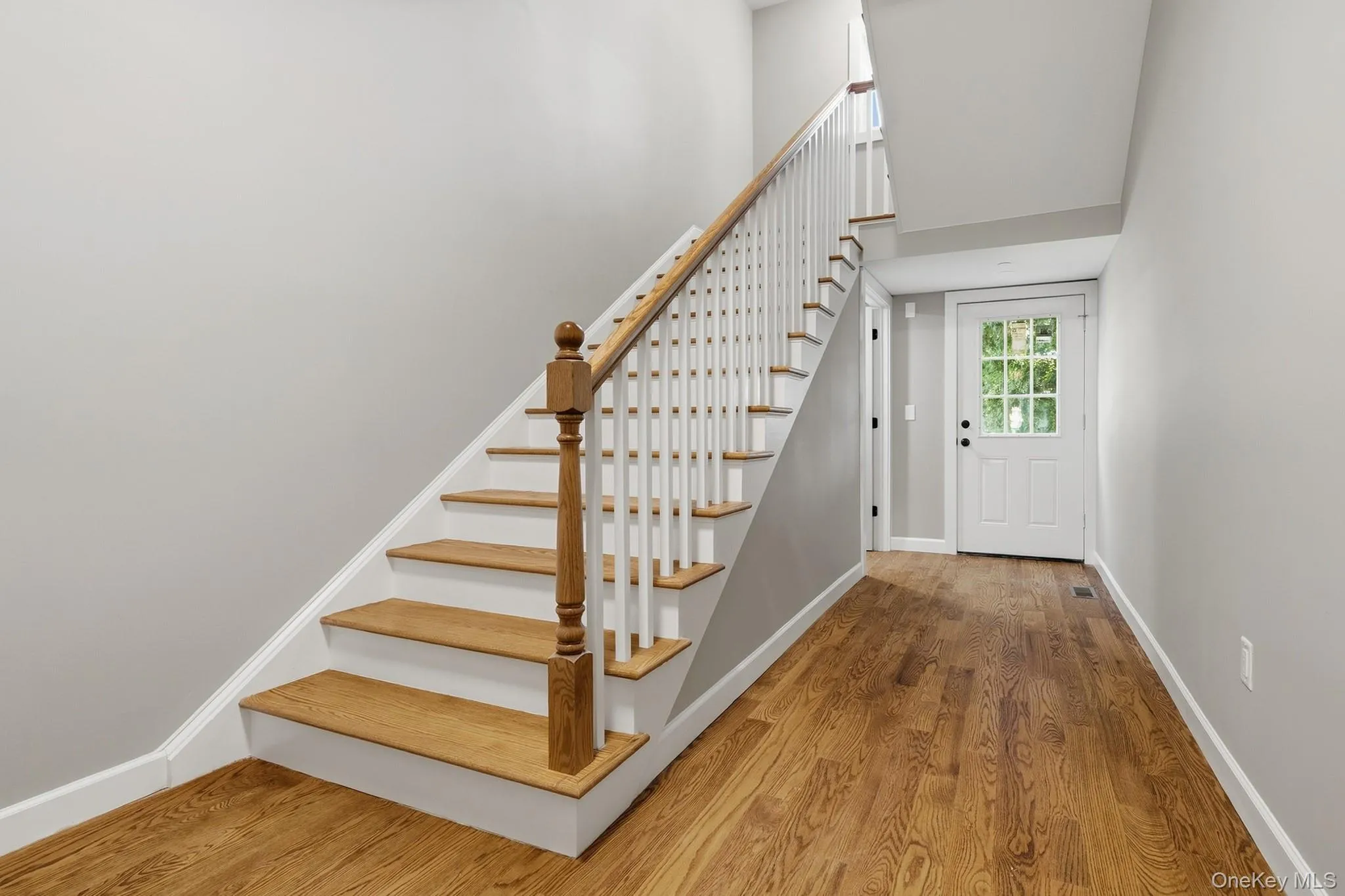 Stairs up to 2nd floor and access to back yard Stairs up to 2nd floor and access to back yard