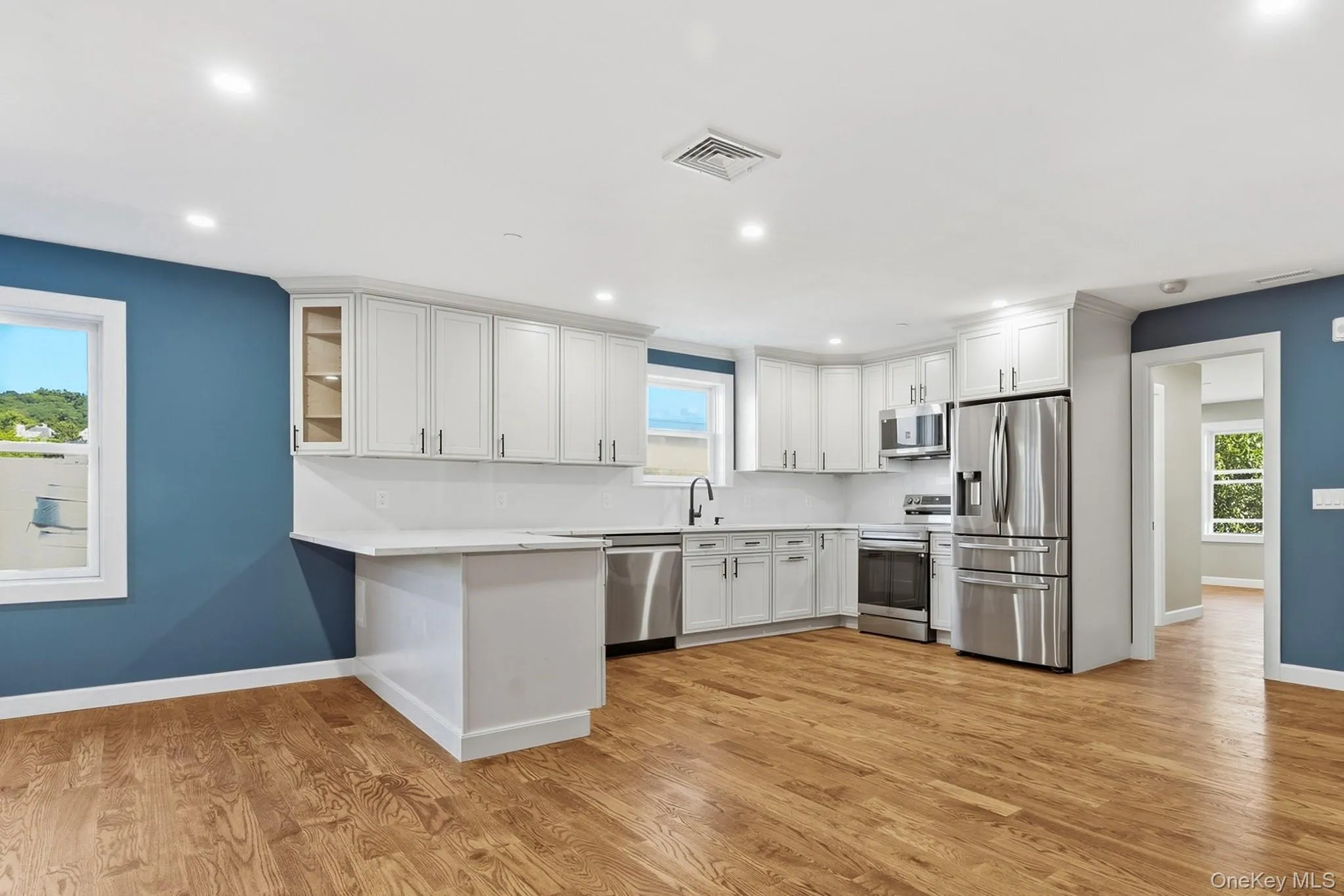 Kitchen and breakfast bar with primary bedroom to the right Kitchen and breakfast bar with primary bedroom to the right