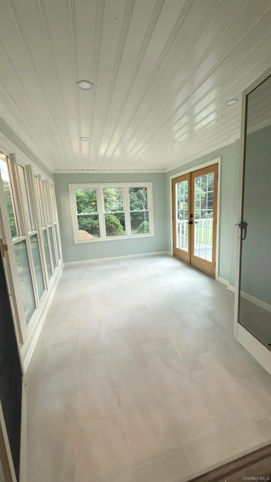All season porch with radiant heated floors, open to dining room via double doors. All season porch with radiant heated floors, open to dining room via double doors.