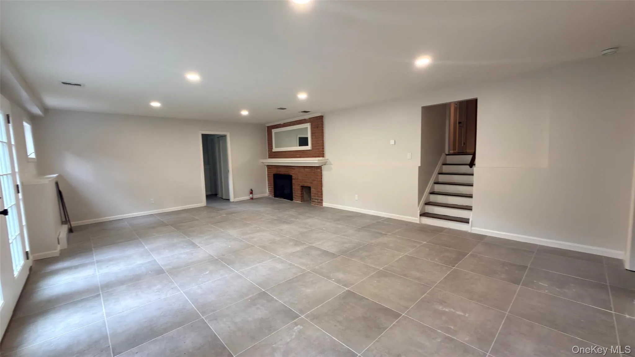 Downstairs Den, brand new floors. On this level, you have the laundry room, 4th bedroom, 1.2 bathroom, direct access to rear yard. (Use of fireplace not included) Downstairs Den, brand new floors. On this level, you have the laundry room, 4th bedroom, 1.2 bathroom, direct access to rear yard. (Use of fireplace not included)