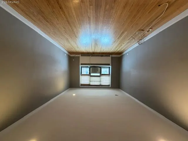Hardwood flooring, recessed lighting, window, crown molding, and a window air conditioning unit Hardwood flooring, recessed lighting, window, crown molding, and a window air conditioning unit