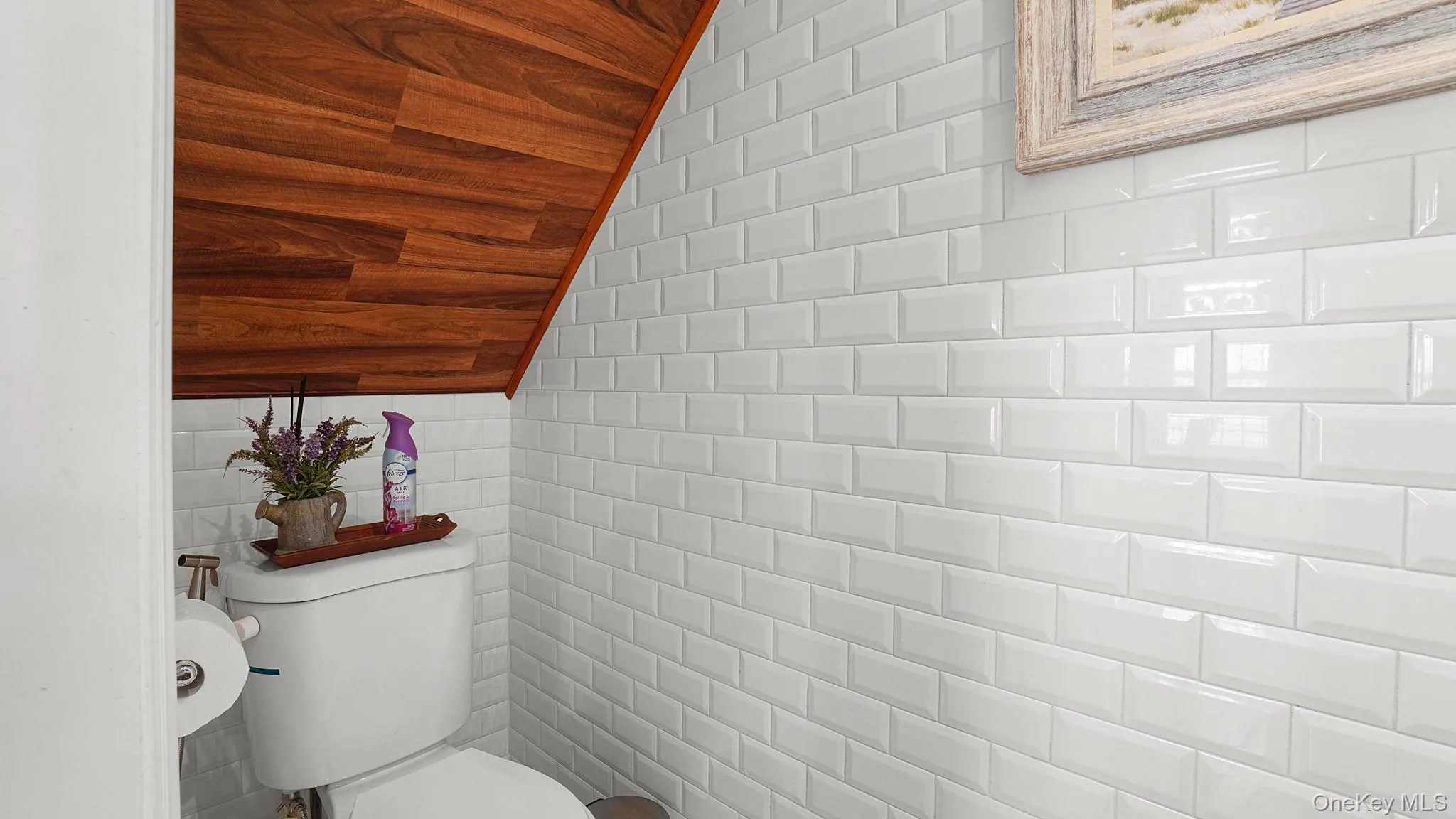 White subway tile wall covering with a wood-finish ceiling White subway tile wall covering with a wood-finish ceiling