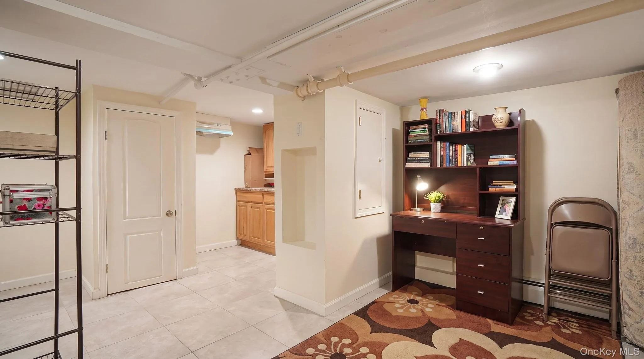Recessed lighting illuminating a versatile room with tile flooring and painted walls Recessed lighting illuminating a versatile room with tile flooring and painted walls