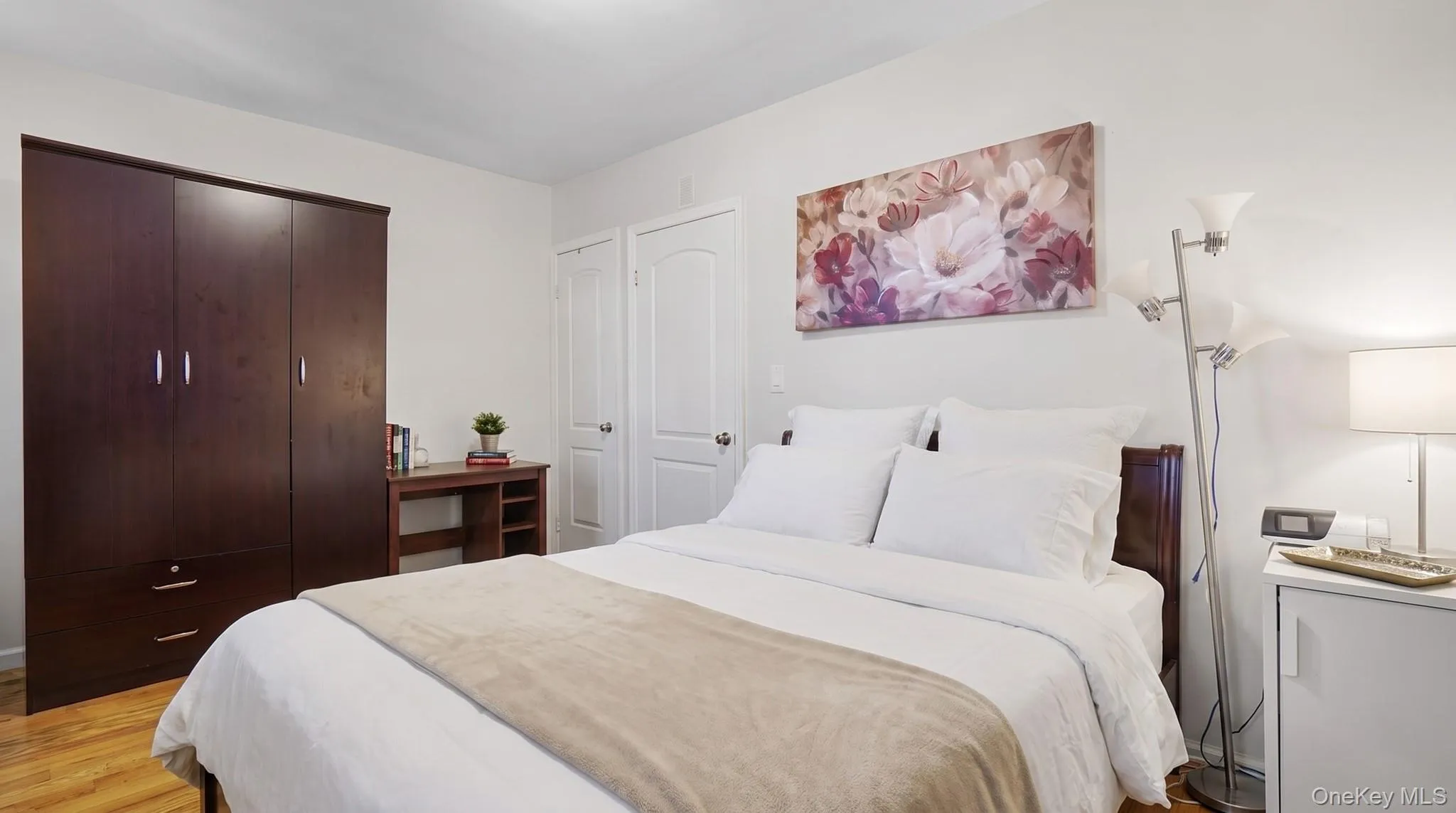 Hardwood-style flooring, white walls, and built-in closet Hardwood-style flooring, white walls, and built-in closet