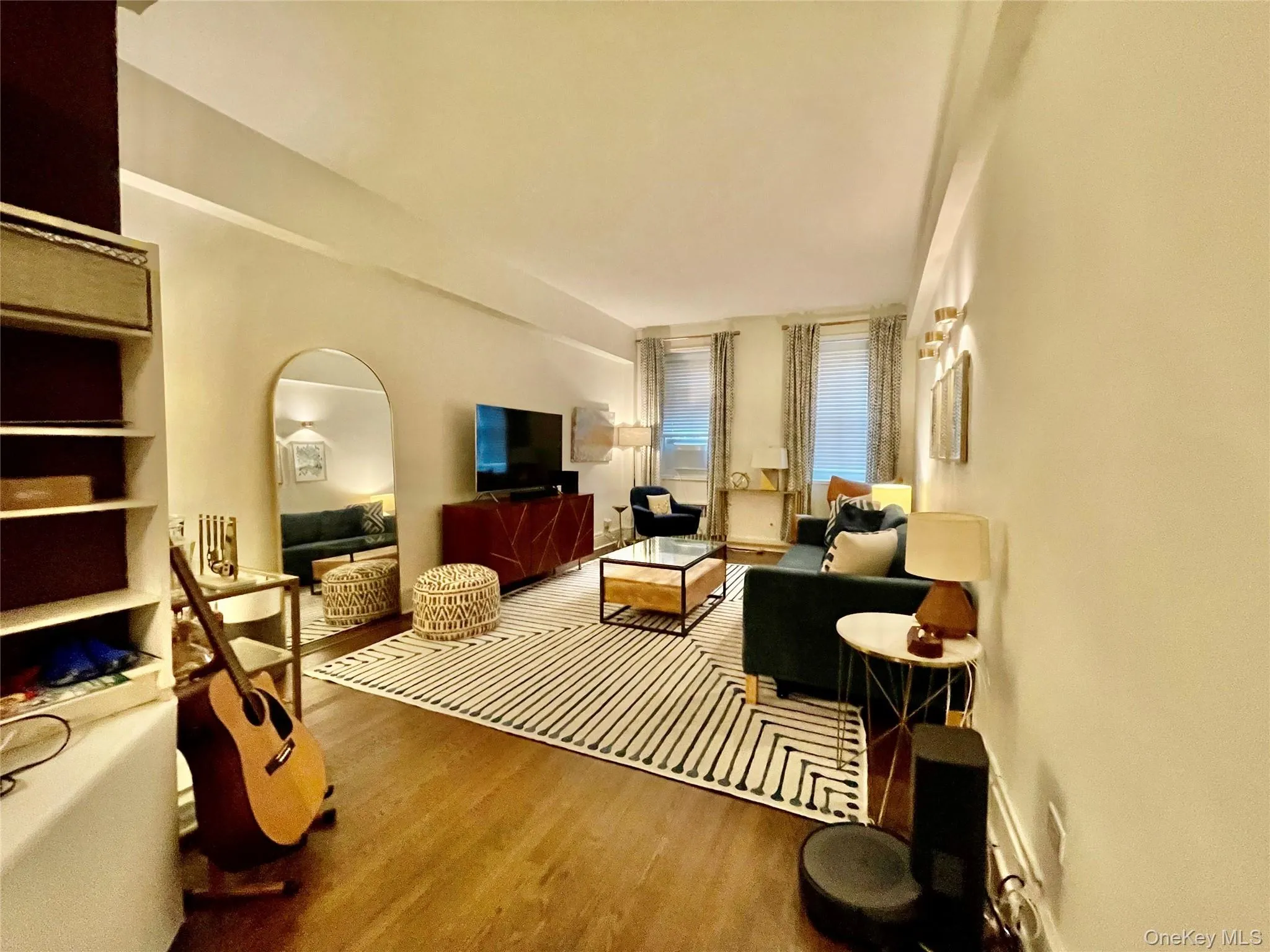 Wood-finish flooring throughout, with recessed lighting and wall-mounted sconces Wood-finish flooring throughout, with recessed lighting and wall-mounted sconces