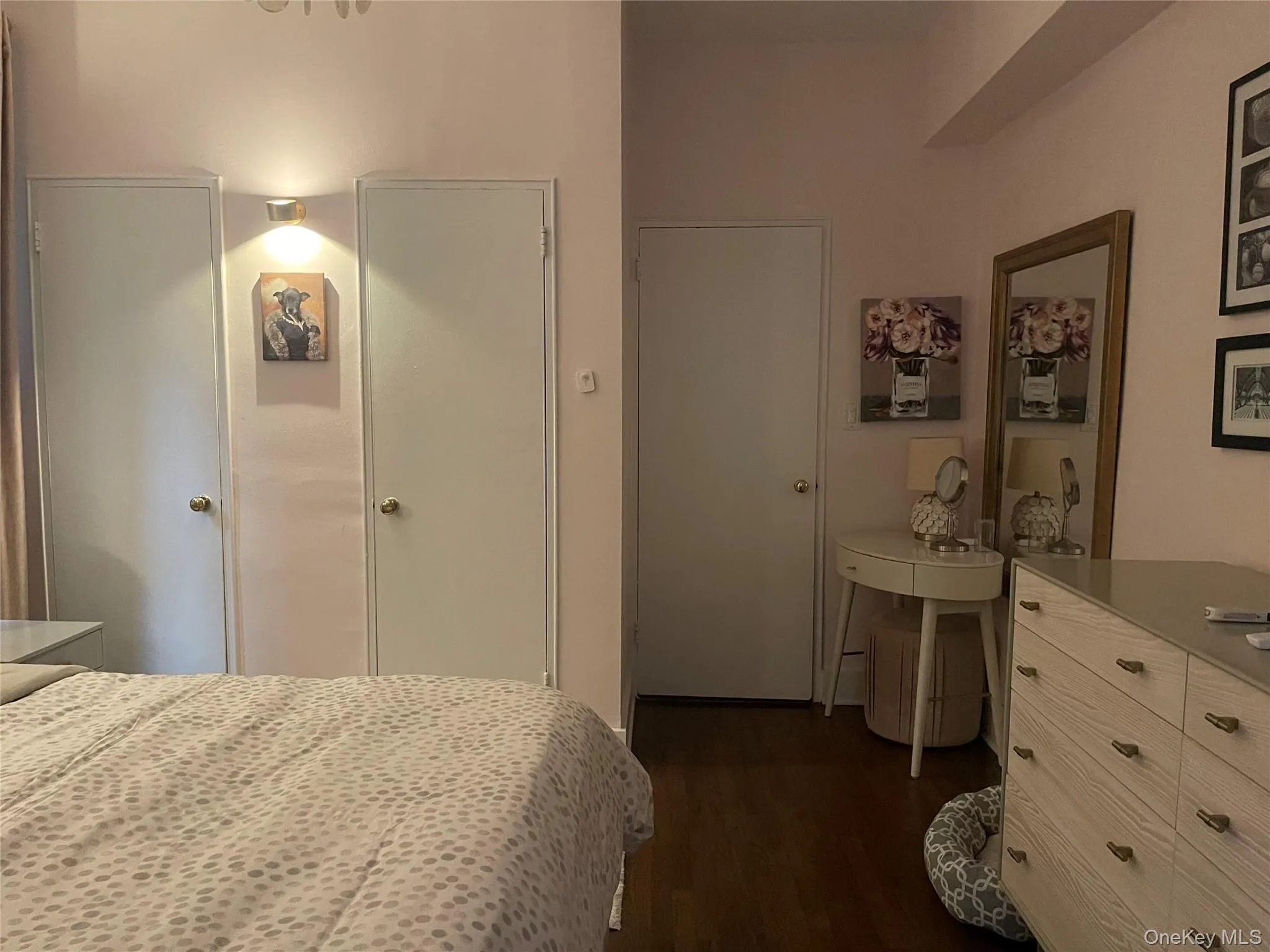Hardwood-style flooring and a wall-mounted light fixture Hardwood-style flooring and a wall-mounted light fixture