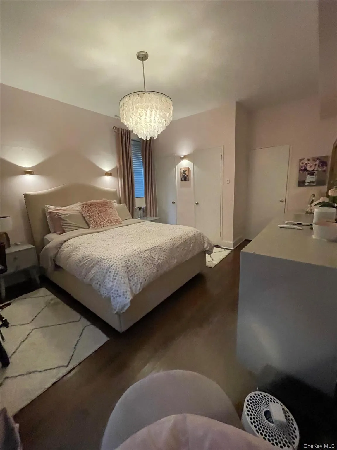 Wood-finish flooring, two wall sconces, ceiling-mounted chandelier, and built-in closet doors Wood-finish flooring, two wall sconces, ceiling-mounted chandelier, and built-in closet doors
