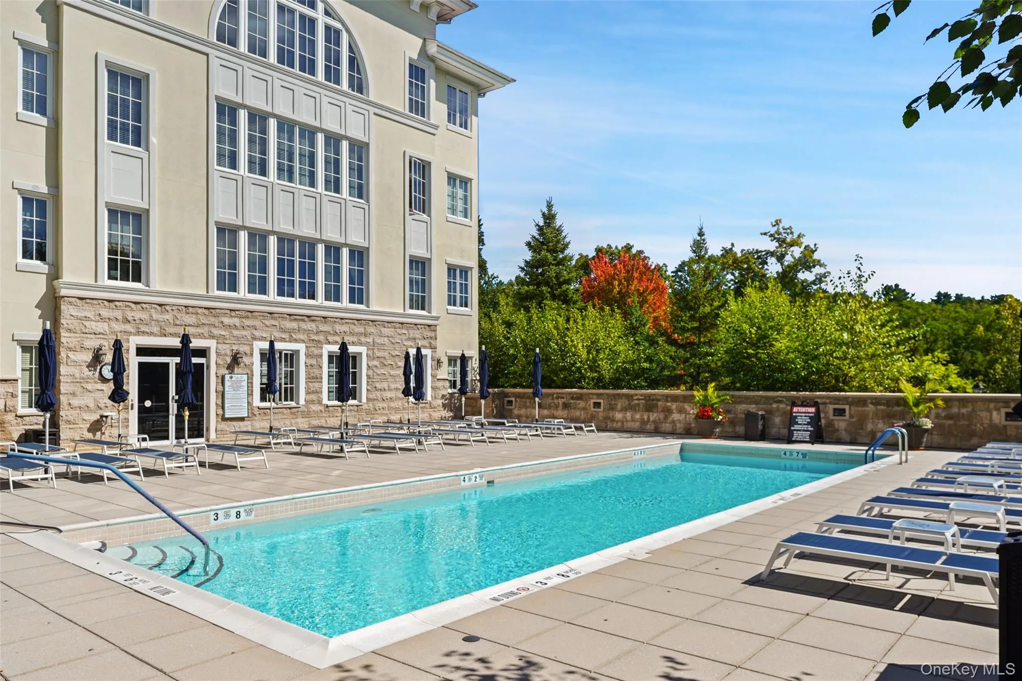 Outdoor swimming pool with integrated entry steps and surrounding deck Outdoor swimming pool with integrated entry steps and surrounding deck