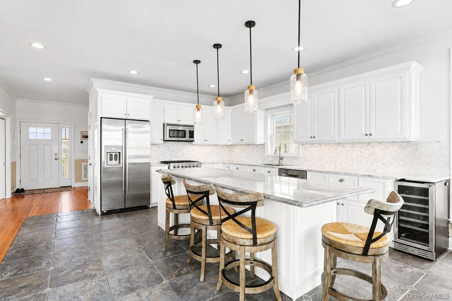 Chefs kitchen with oversized granite kitchen island with high end stainless steel appliances Chefs kitchen with oversized granite kitchen island with high end stainless steel appliances