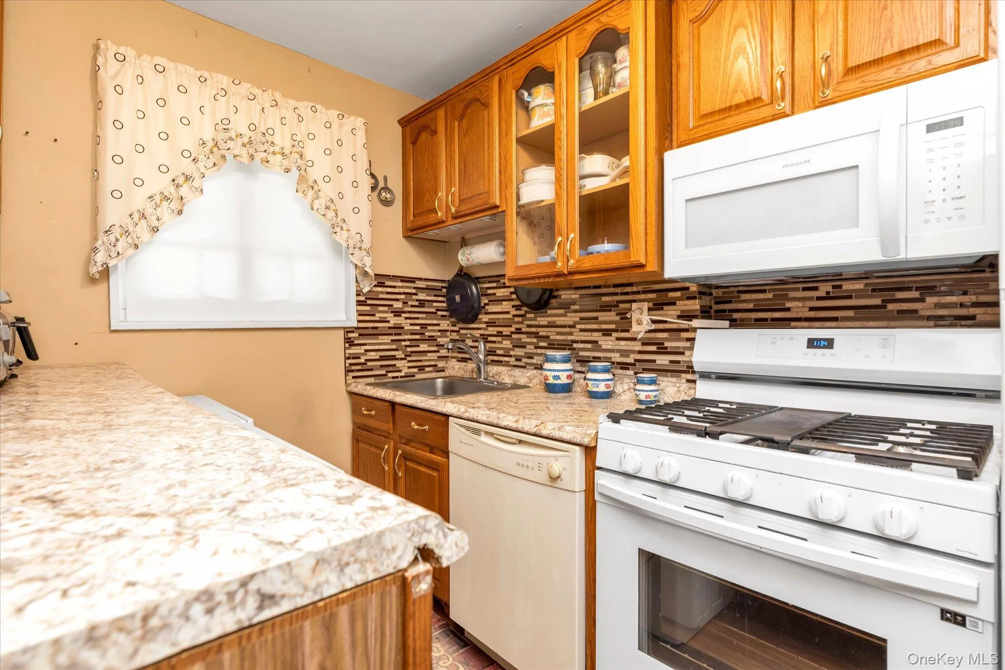 Glass cabinet doors on both sides of the kitchen allow you display your dishes or stemware Glass cabinet doors on both sides of the kitchen allow you display your dishes or stemware