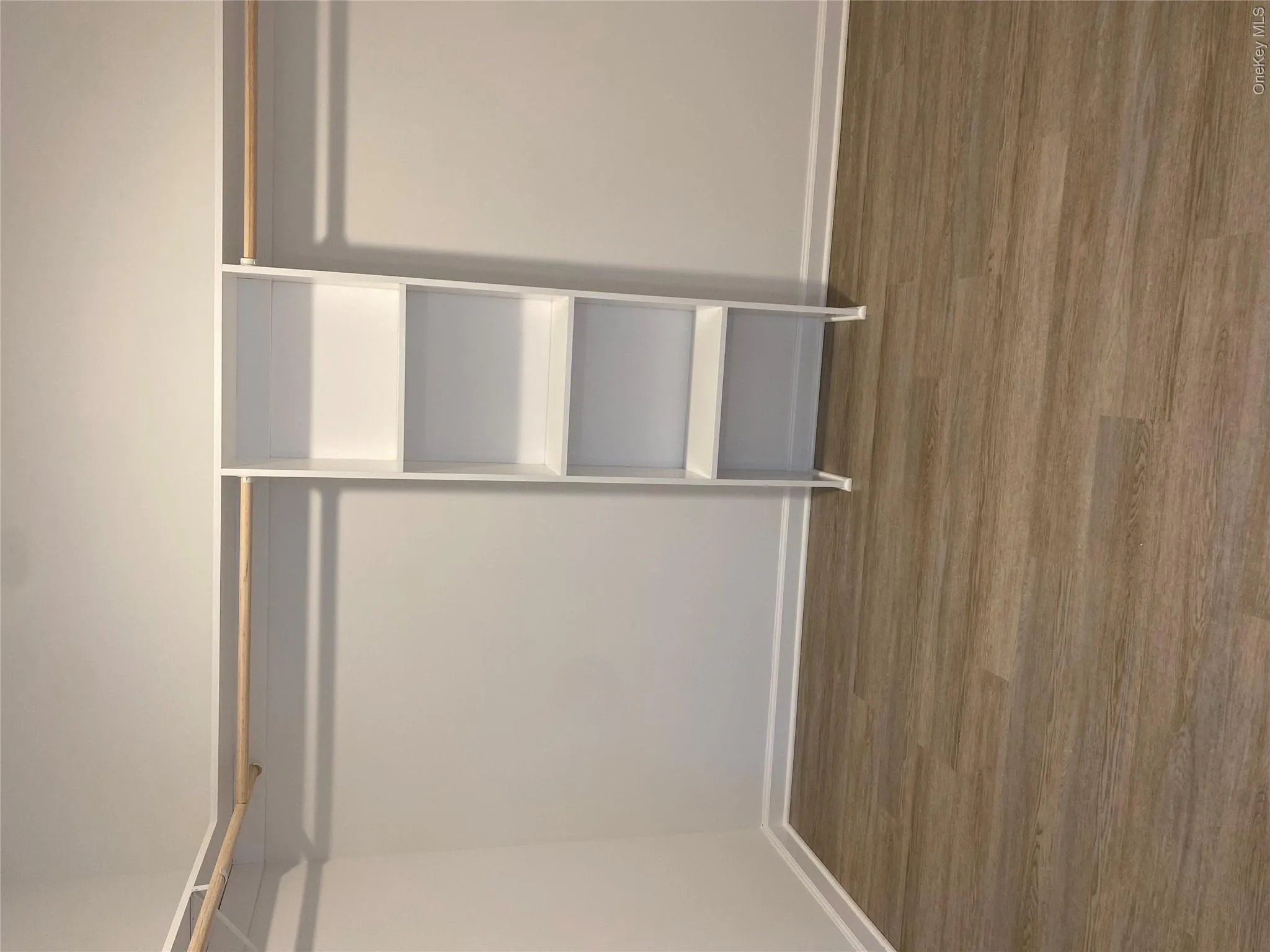 Spacious closet featuring wood finished floors Spacious closet featuring wood finished floors