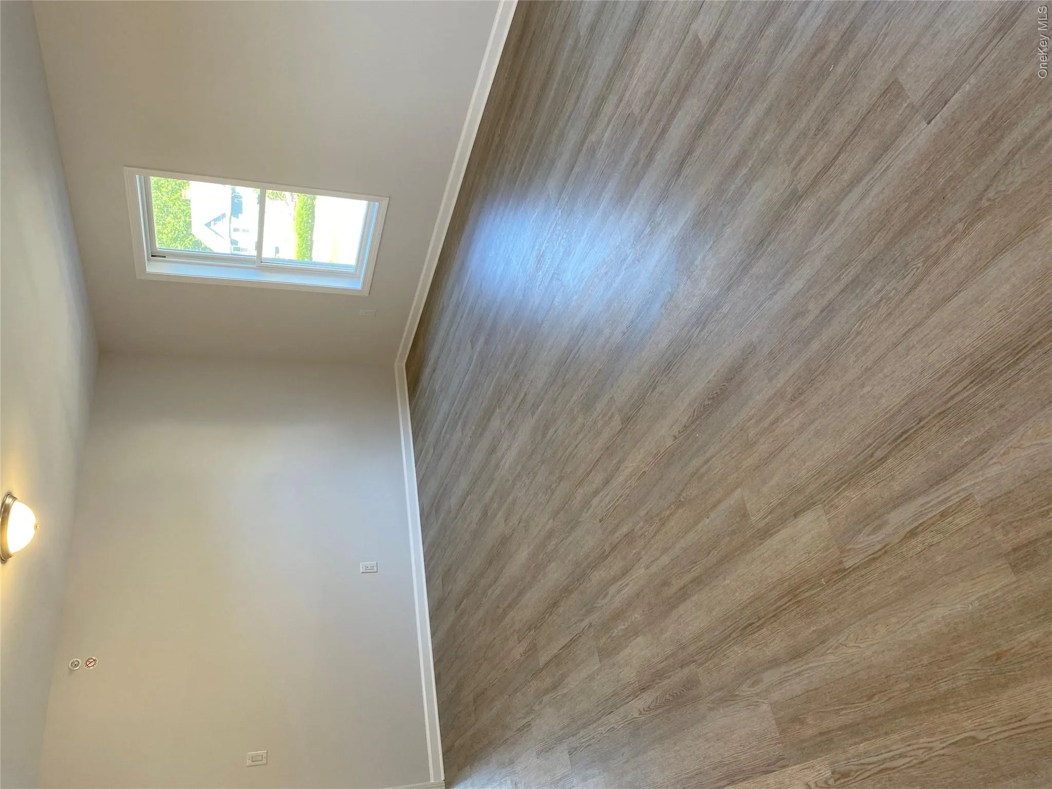 Unfurnished room featuring light wood-style floors Unfurnished room featuring light wood-style floors