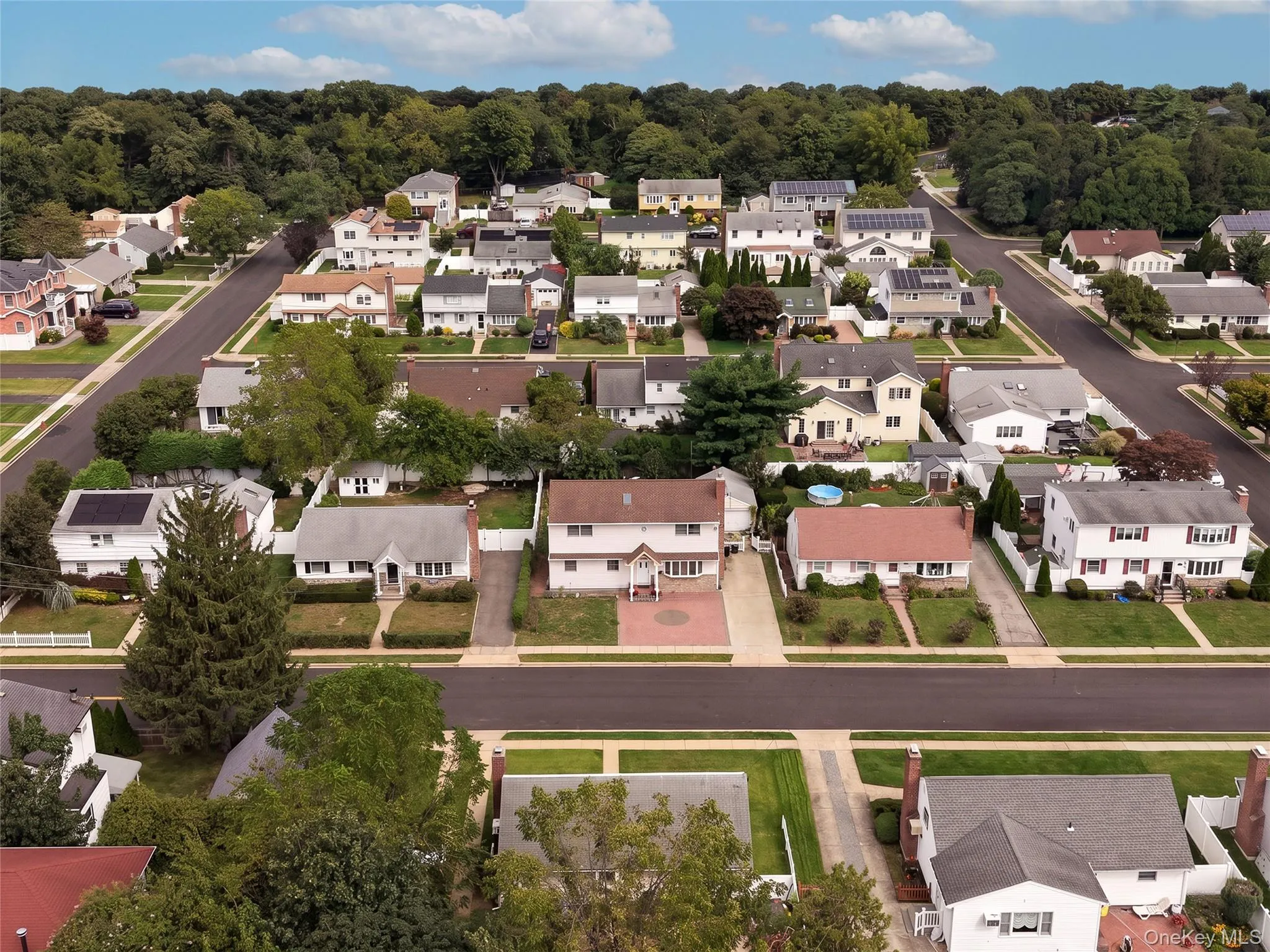 Residential neighborhood with paved streets and mature trees Residential neighborhood with paved streets and mature trees