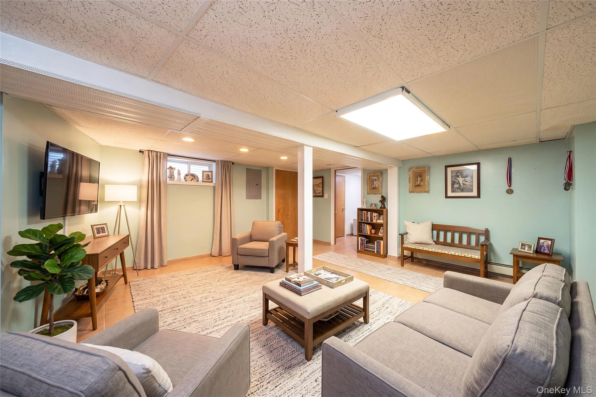 Recessed lighting, wood-finish flooring, drop ceiling, and a built-in bookshelf Recessed lighting, wood-finish flooring, drop ceiling, and a built-in bookshelf