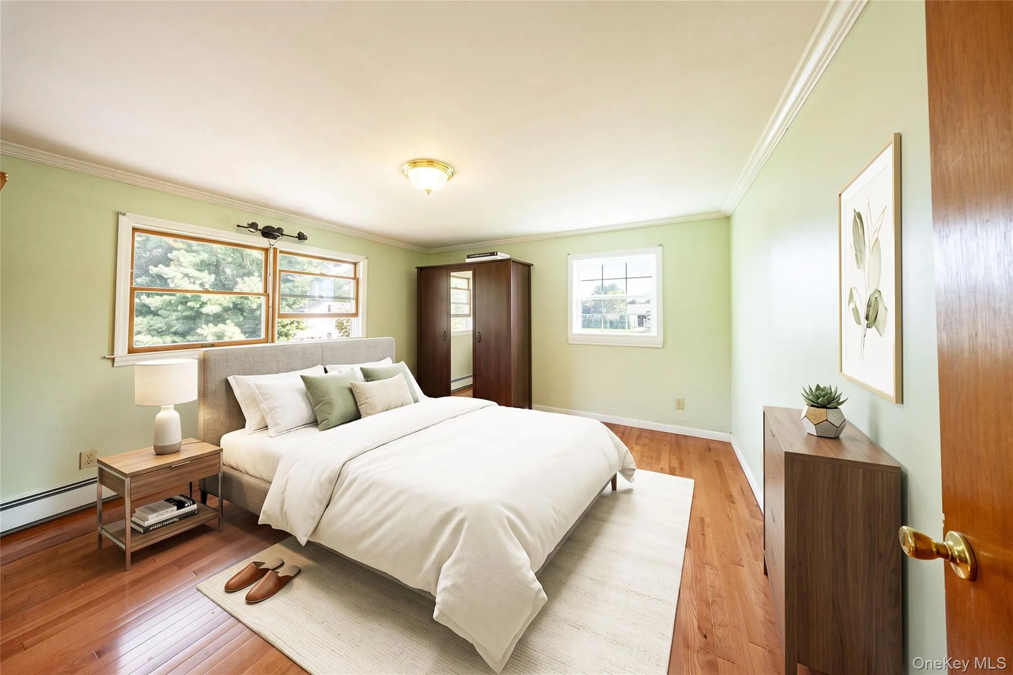 Hardwood-style flooring, crown molding, double casement window, single casement window, and a flush mount ceiling fixture Hardwood-style flooring, crown molding, double casement window, single casement window, and a flush mount ceiling fixture