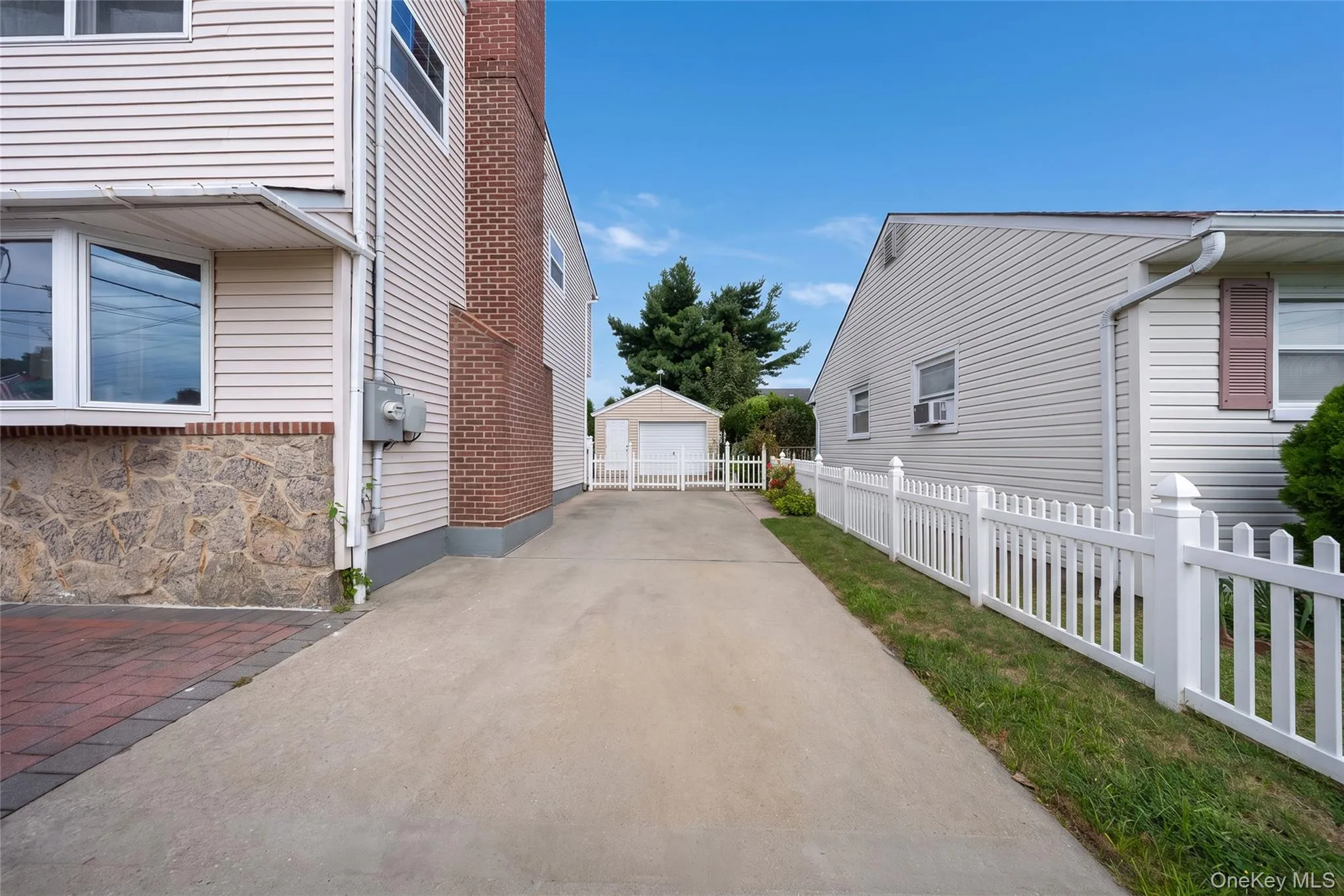 Concrete driveway leading to a detached garage Concrete driveway leading to a detached garage