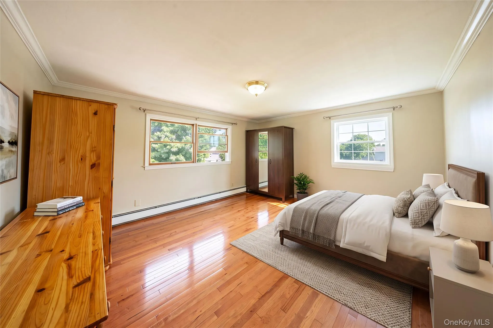 Hardwood flooring throughout, crown molding, double windows, and a ceiling-mounted light fixture Hardwood flooring throughout, crown molding, double windows, and a ceiling-mounted light fixture