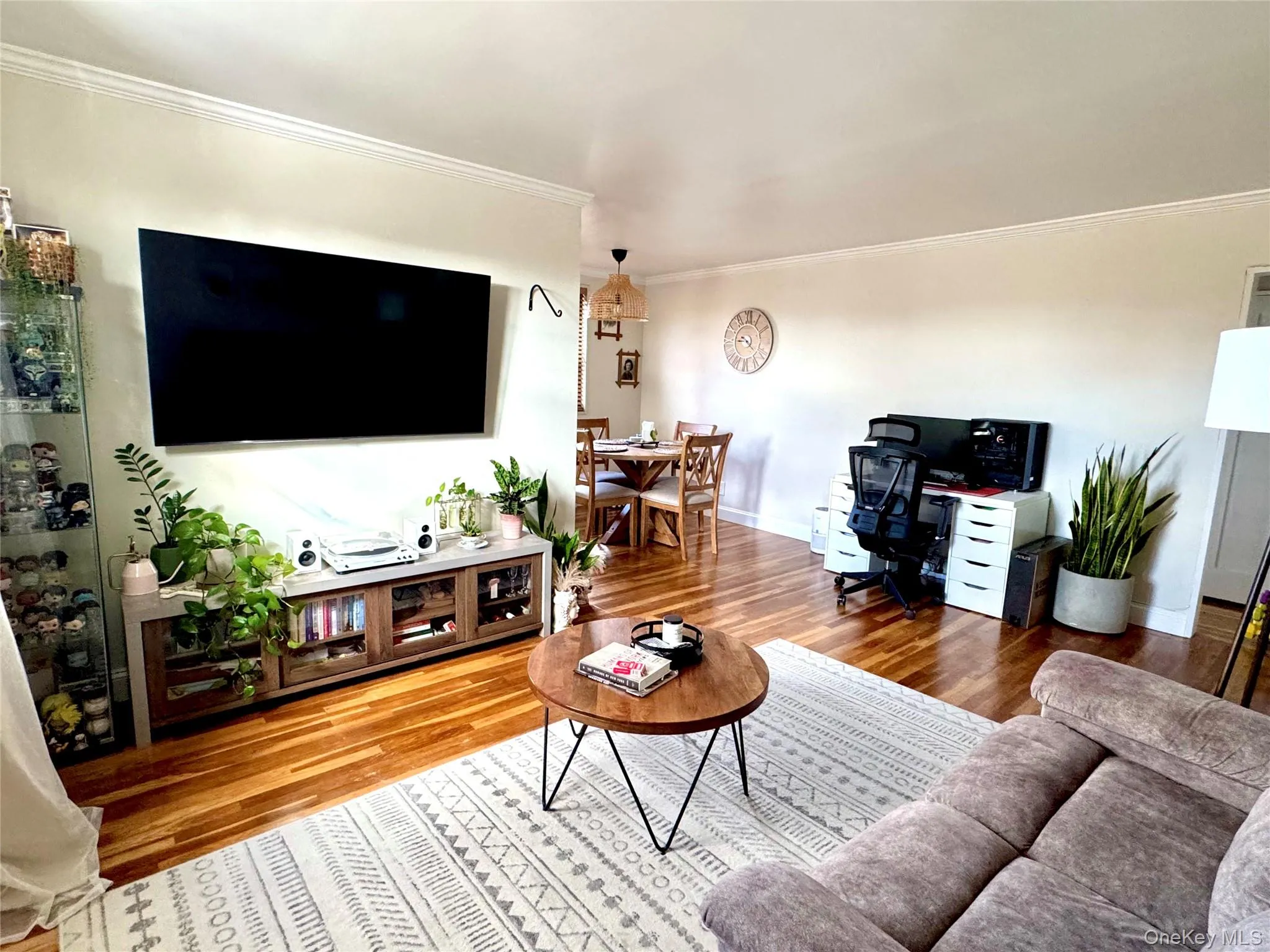 Wood-finish flooring throughout with crown molding Wood-finish flooring throughout with crown molding