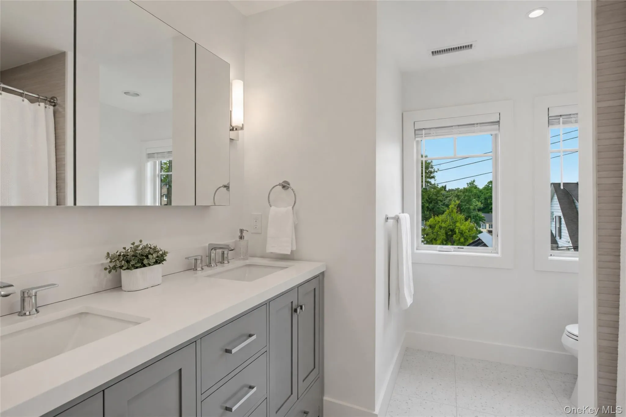 Bathroom with dual vanity on second level. Bathroom with dual vanity on second level.