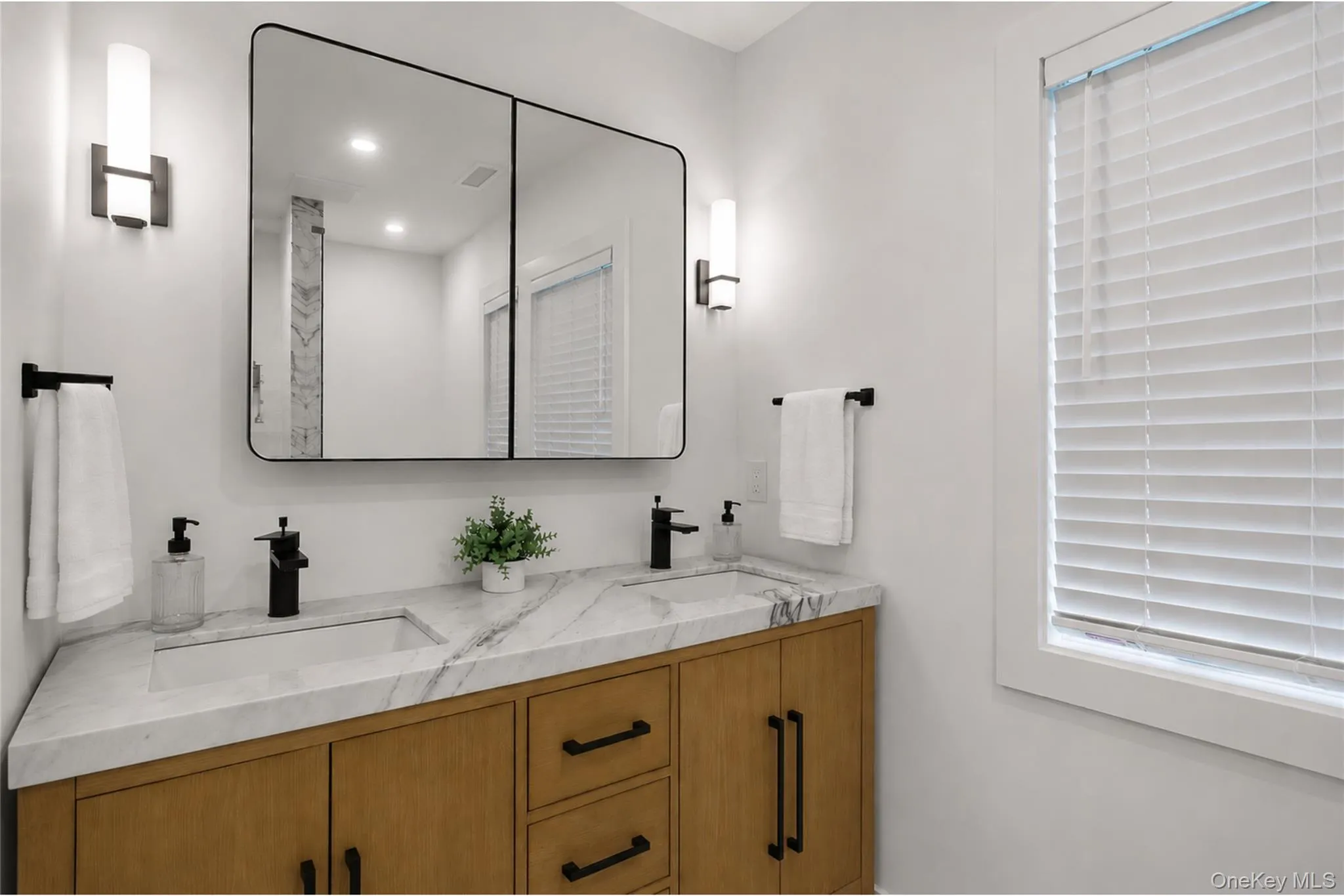Primary bathroom with dual vanity. Primary bathroom with dual vanity.