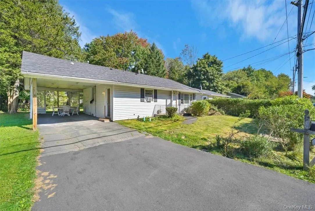 Ranch-style house with a front lawn and a carport Ranch-style house with a front lawn and a carport