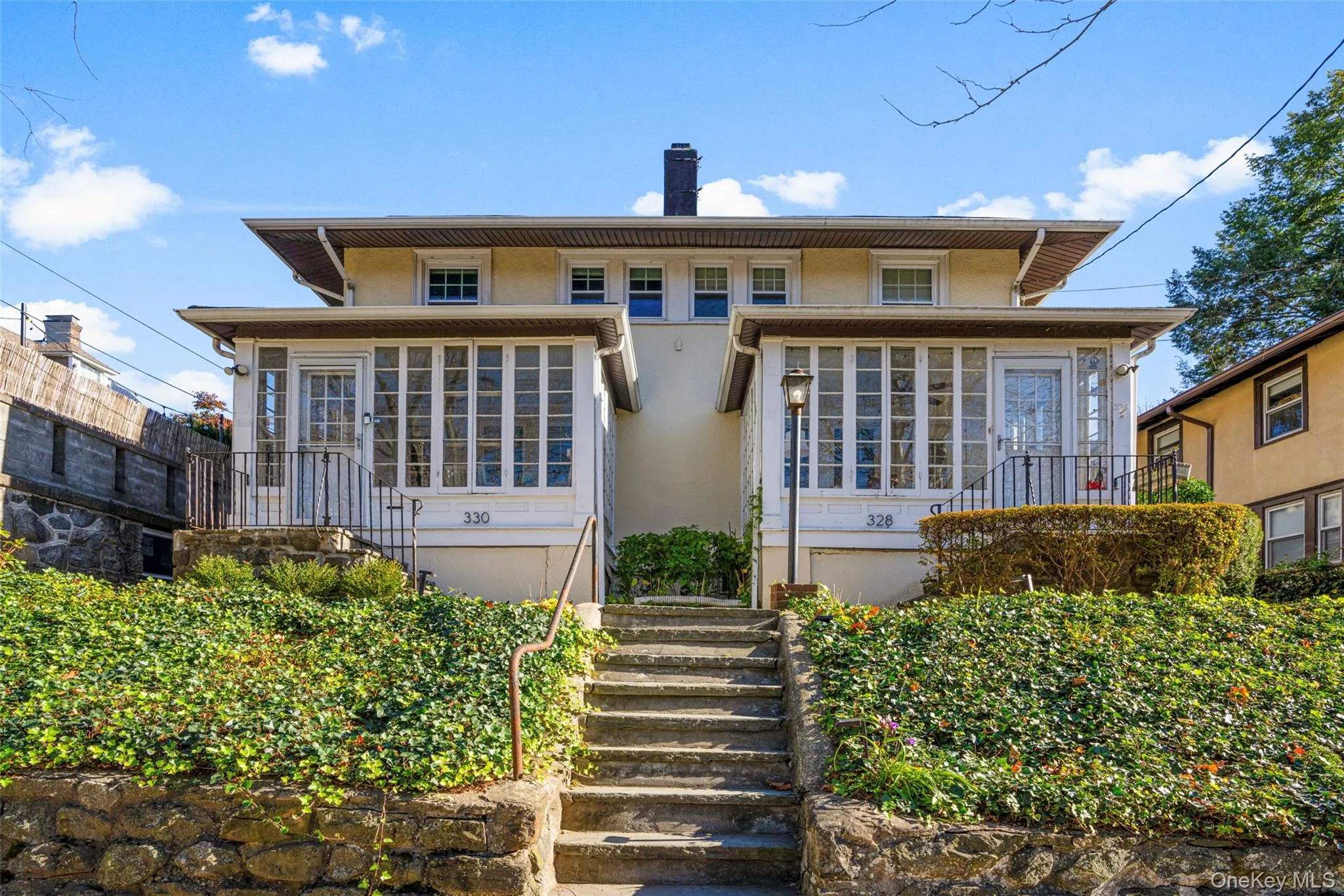 Rear view of property featuring a sunroom Rear view of property featuring a sunroom