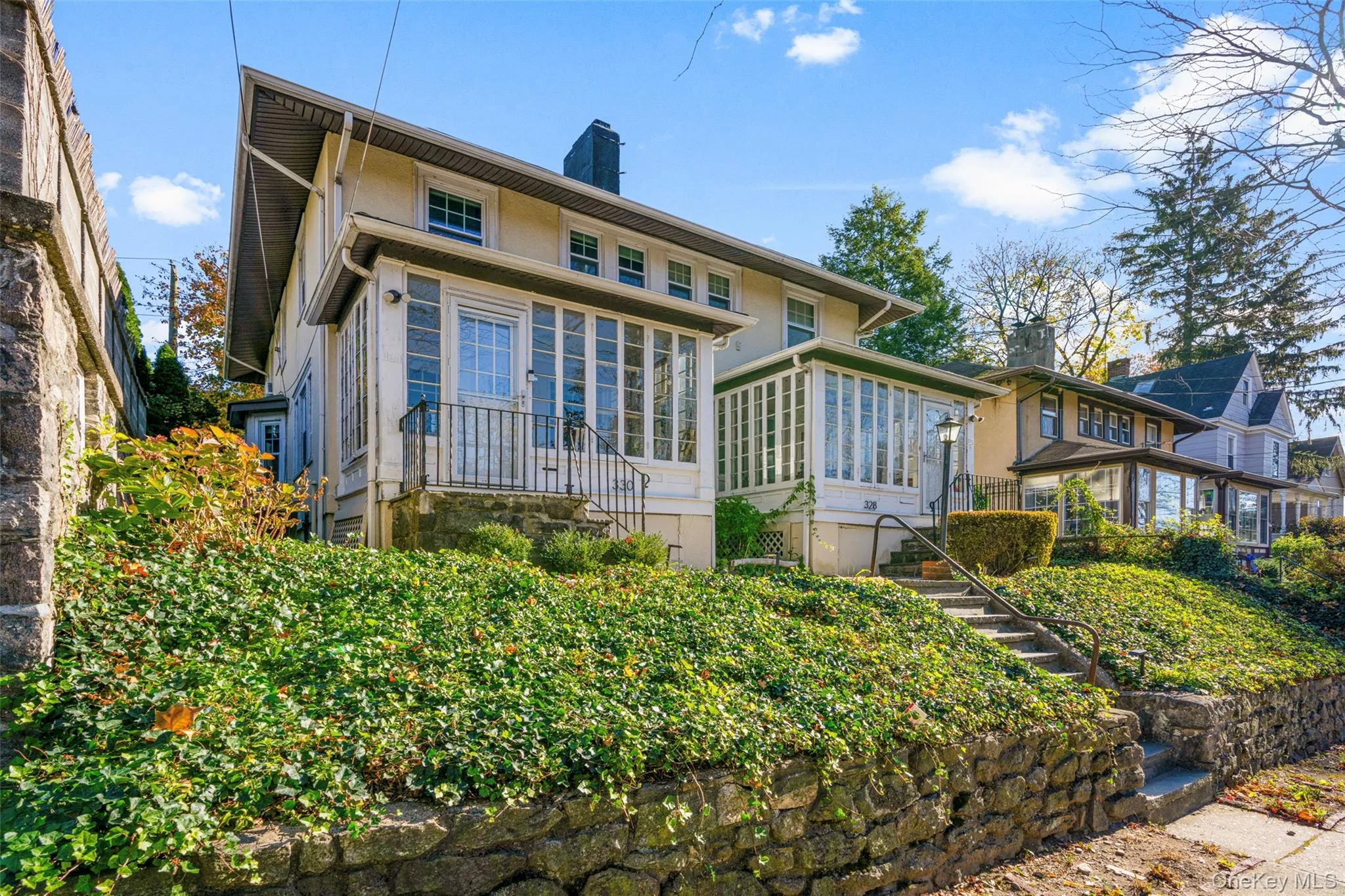 View of front of house featuring a sunroom View of front of house featuring a sunroom