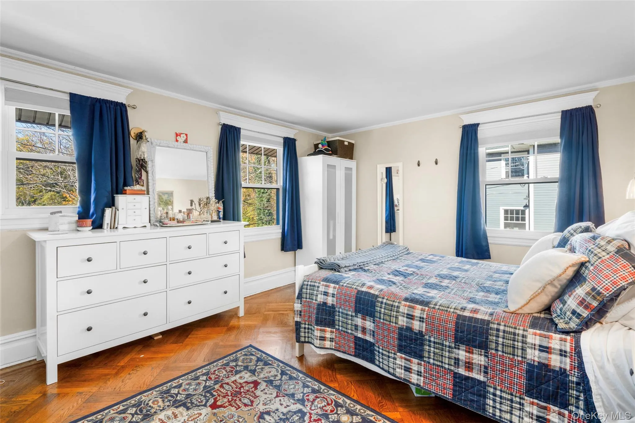 Bedroom with ornamental molding and parquet flooring Bedroom with ornamental molding and parquet flooring