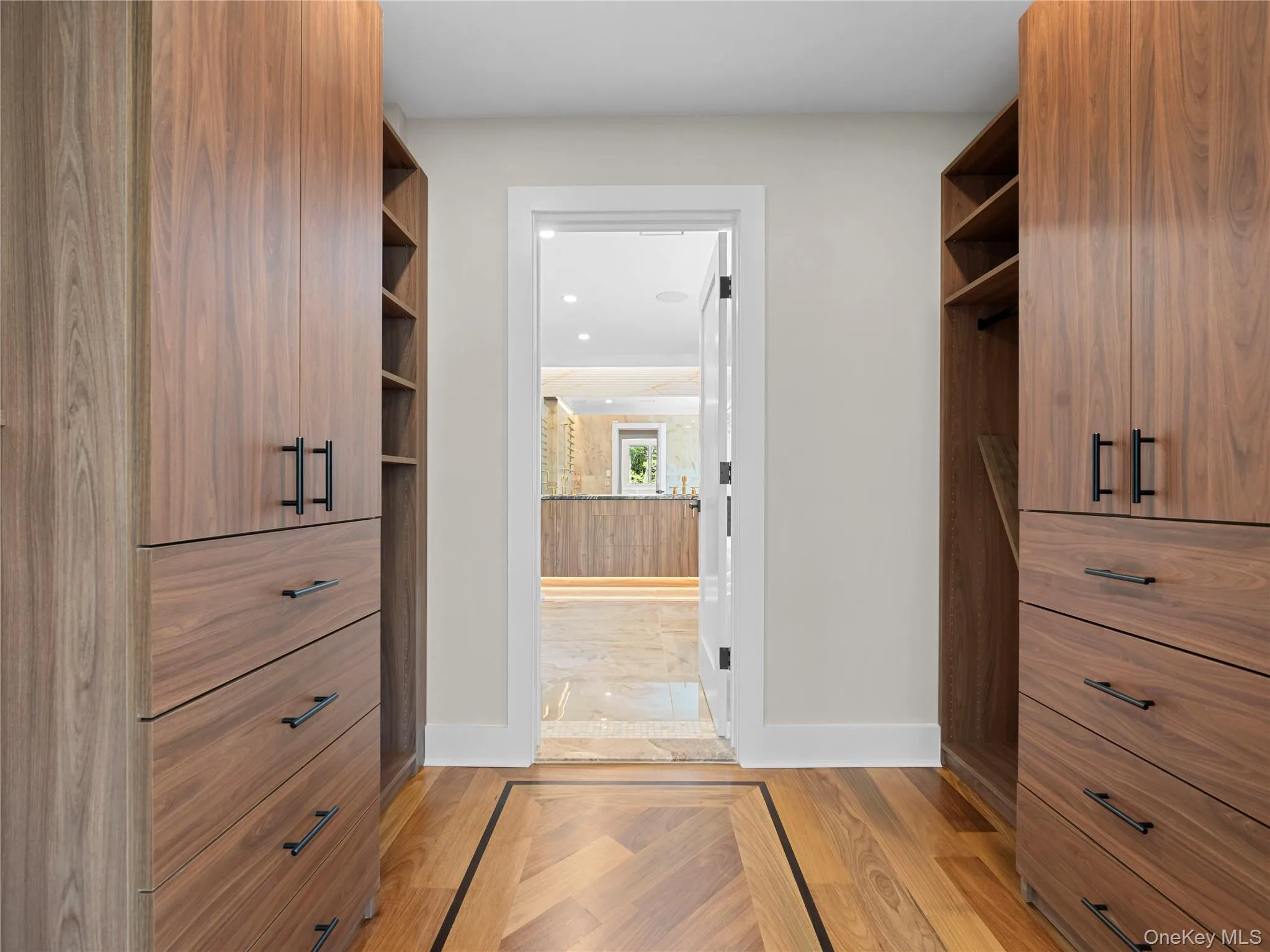Spacious closet with light wood-style flooring Spacious closet with light wood-style flooring