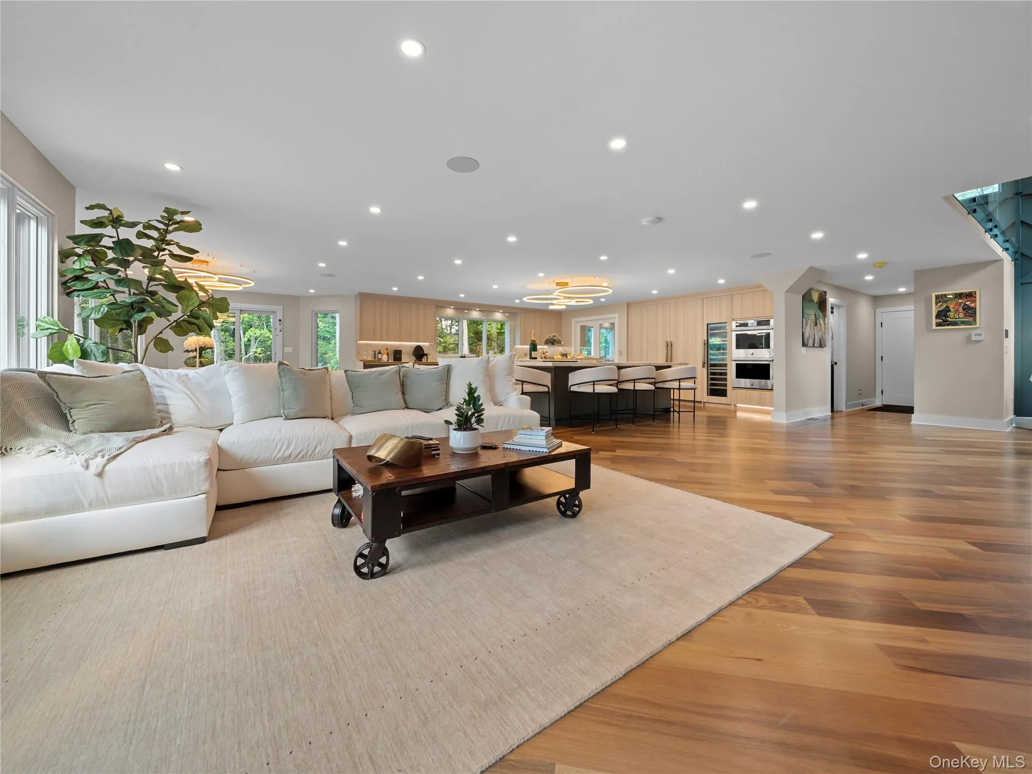 Living room featuring light wood-style floors and recessed lighting Living room featuring light wood-style floors and recessed lighting