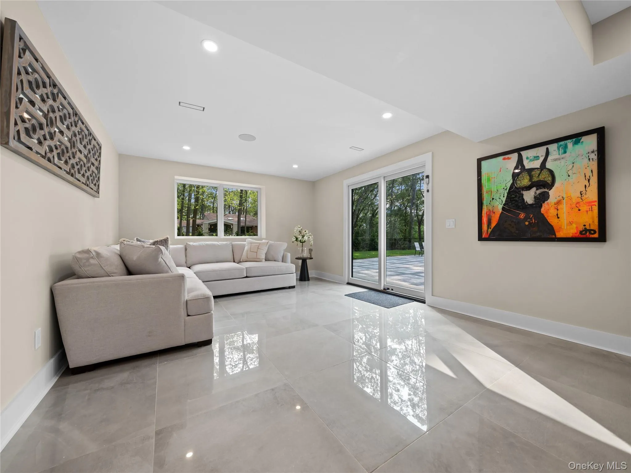 Living room featuring recessed lighting and light marble finish floors Living room featuring recessed lighting and light marble finish floors