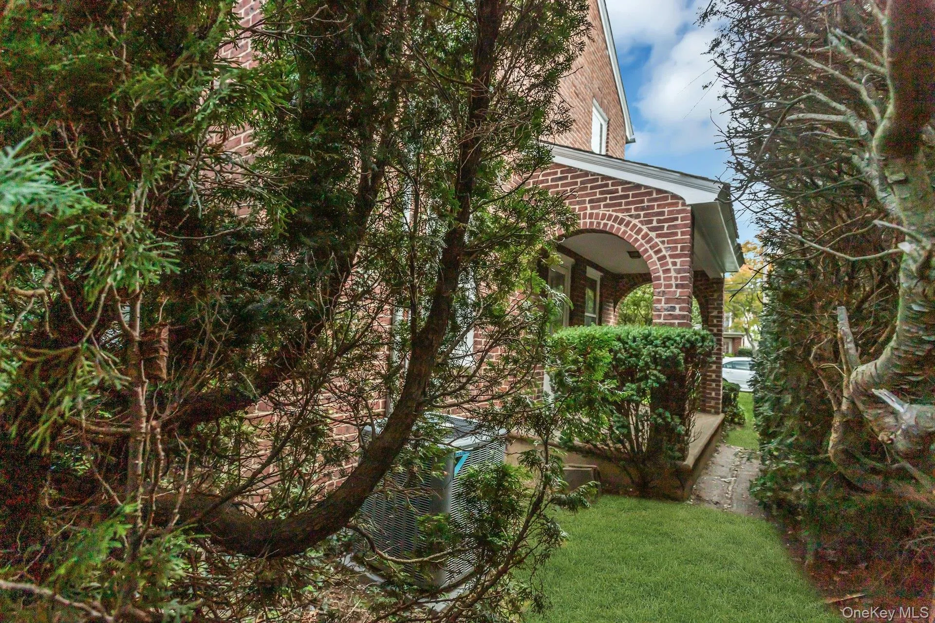 Brick facade with a covered entry and arched columns side porch Brick facade with a covered entry and arched columns side porch