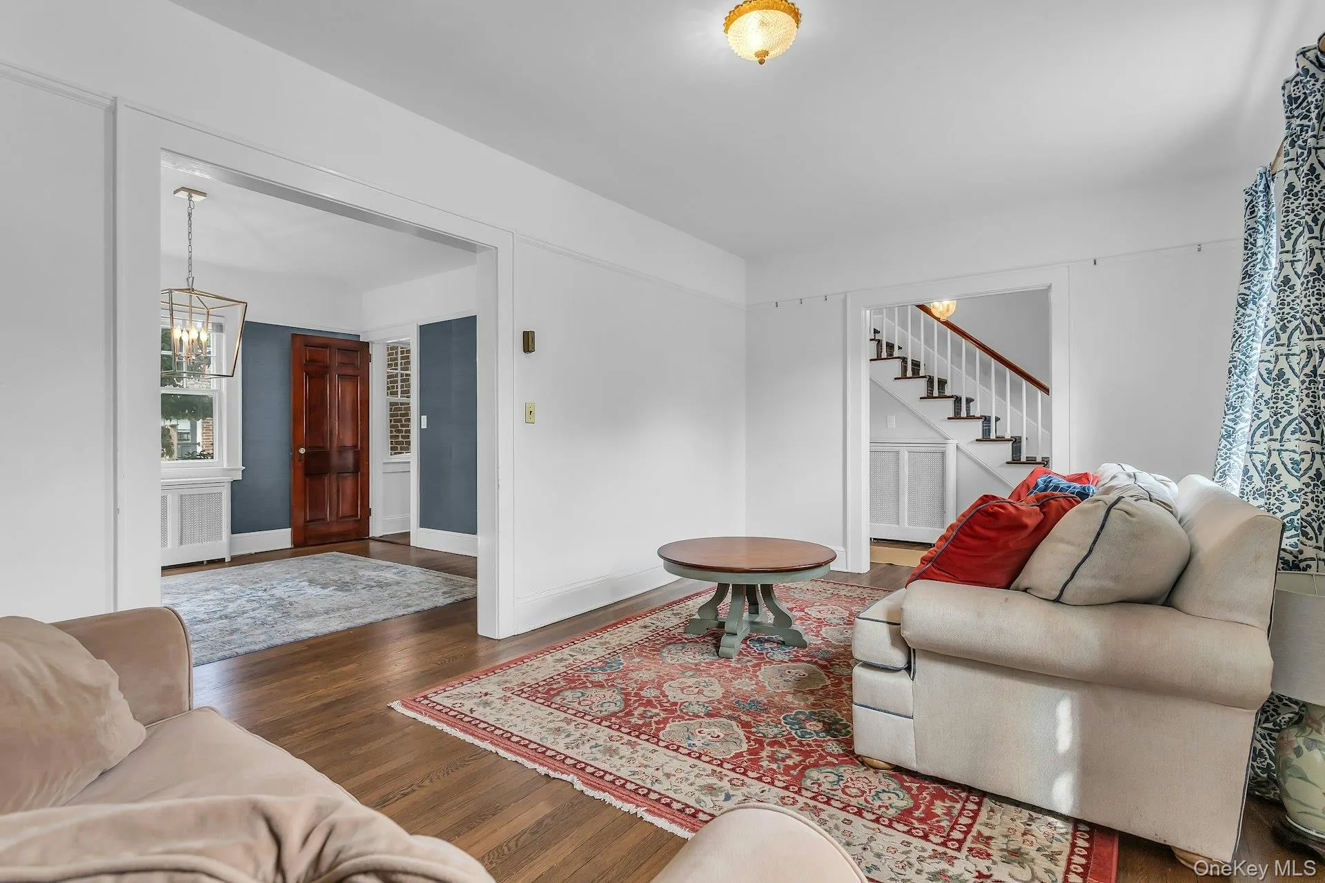 Hardwood flooring throughout, with a traditional staircase and white risers Hardwood flooring throughout, with a traditional staircase and white risers