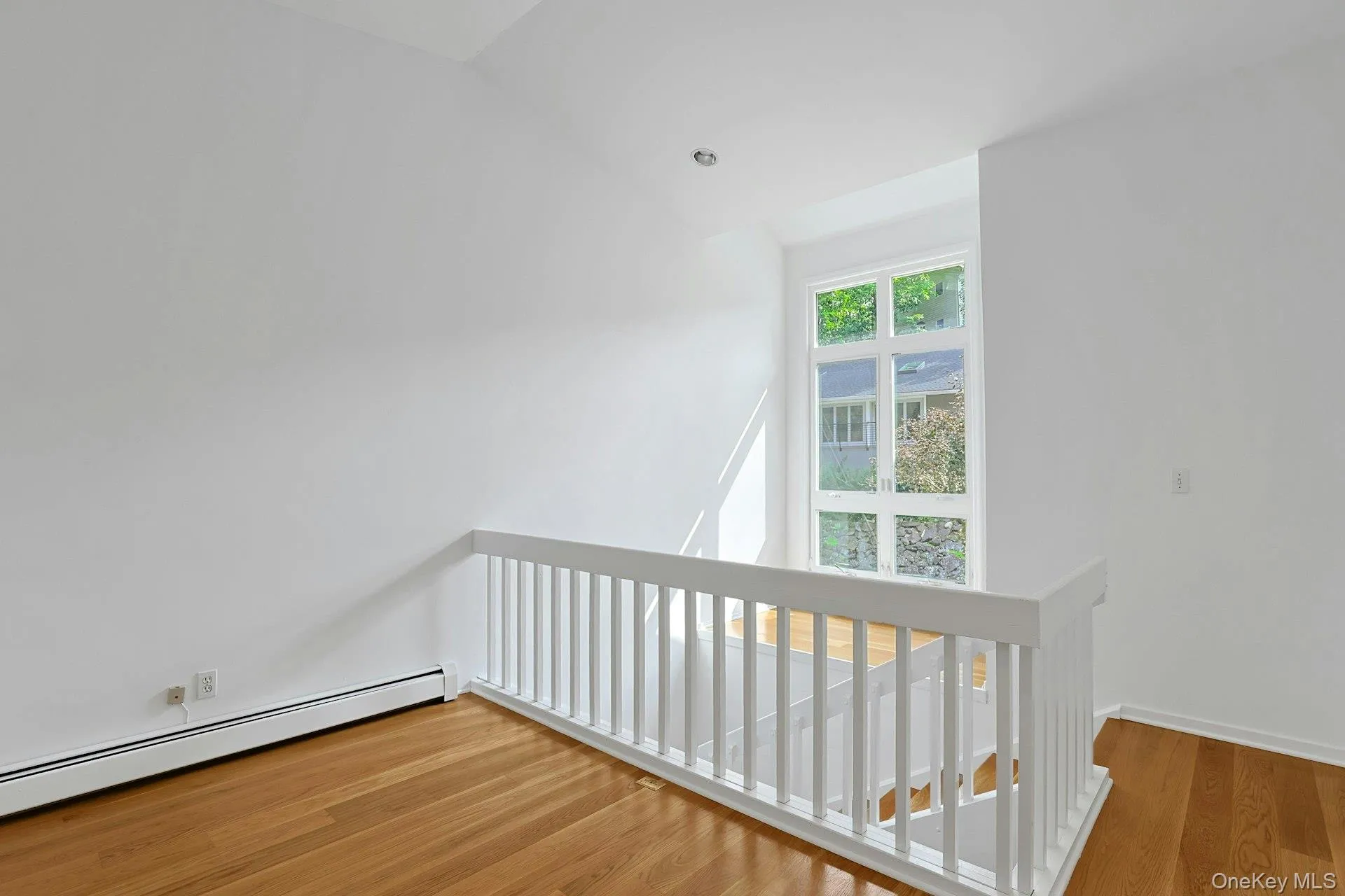 From the loft, we look over to the wall of windows that welcome in tons of natural light. There is a perfect seating area or spot for plants just in front of the window. From the loft, we look over to the wall of windows that welcome in tons of natural light. There is a perfect seating area or spot for plants just in front of the window.