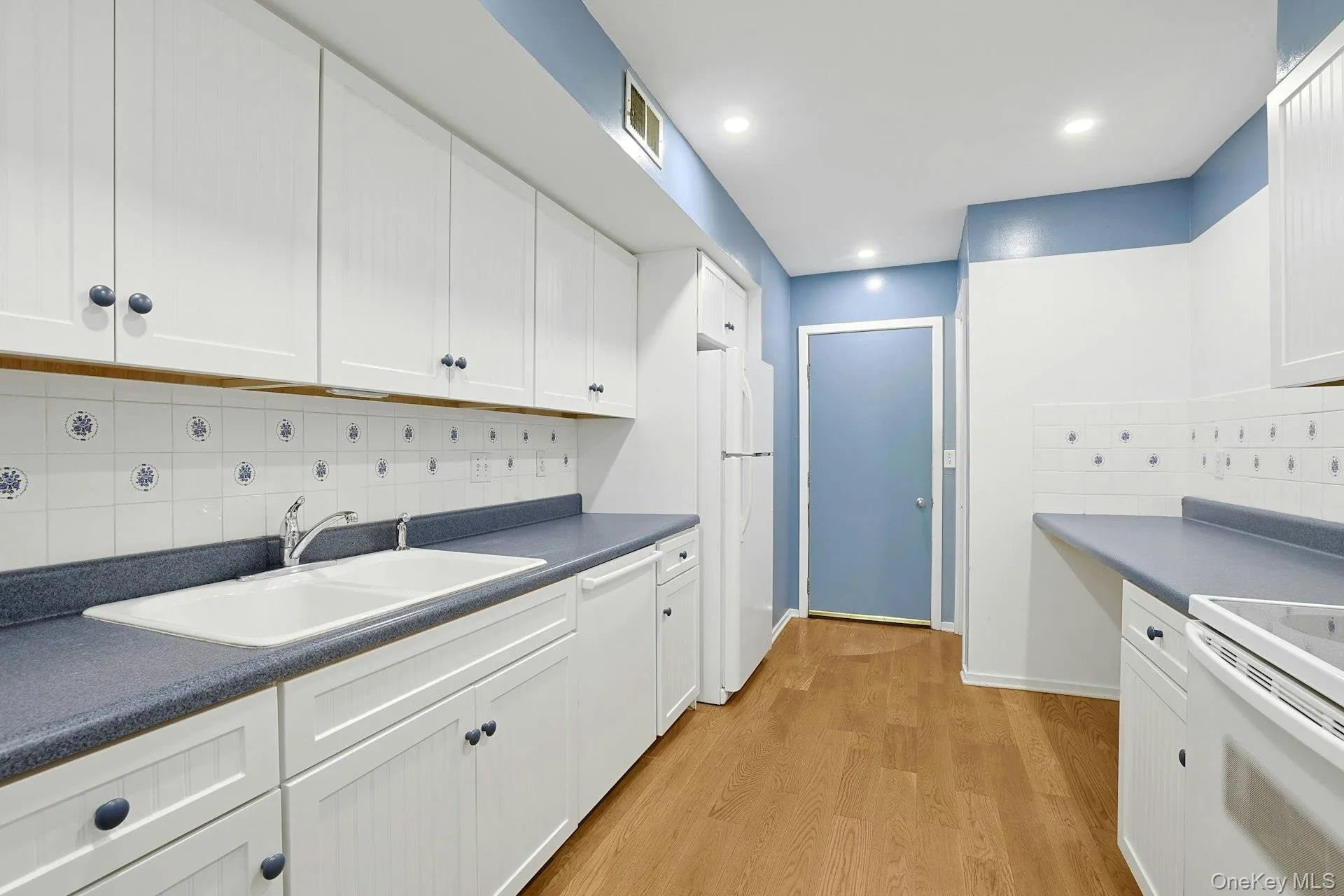 The well designed kitchen has abundant counter and cabinet space. The tried and true V layout for the double sink, oven and refrigerator works for a reason! Cooking in this space will be a treat. There is also plenty of over-head lighting. The well designed kitchen has abundant counter and cabinet space. The tried and true V layout for the double sink, oven and refrigerator works for a reason! Cooking in this space will be a treat. There is also plenty of over-head lighting.